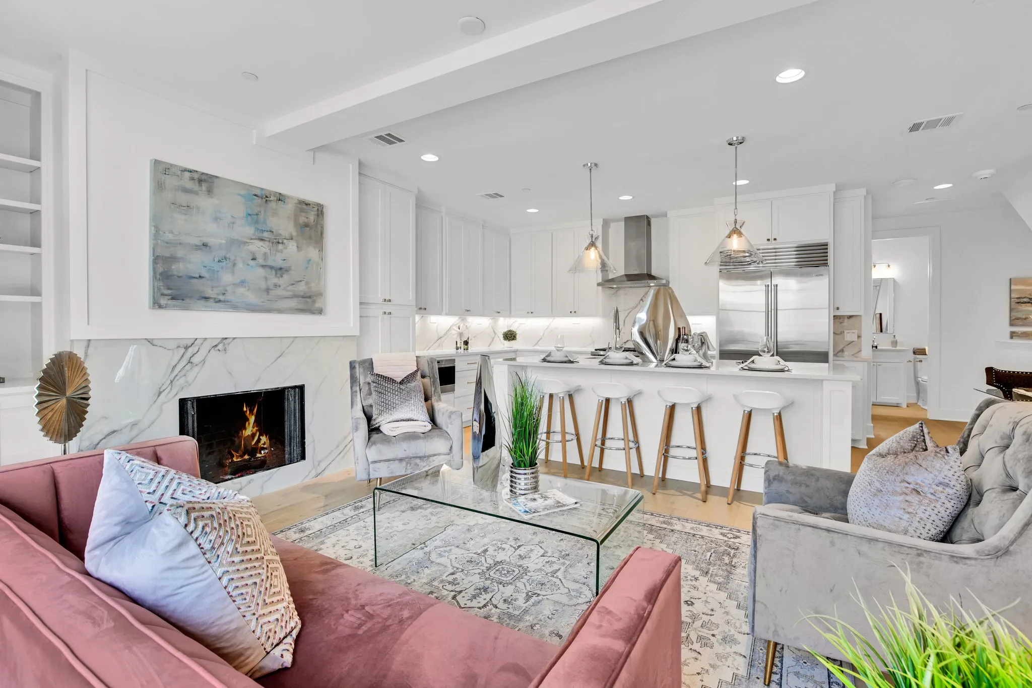 Living area with a premium fireplace, light wood finished floors, and recessed lighting