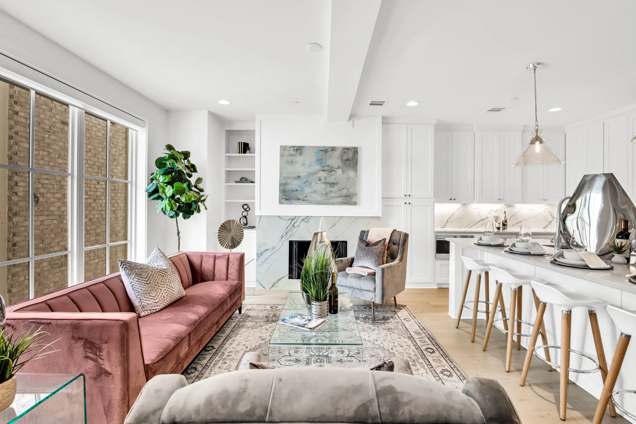 Living area featuring light wood-type flooring, a high end fireplace, and recessed lighting
