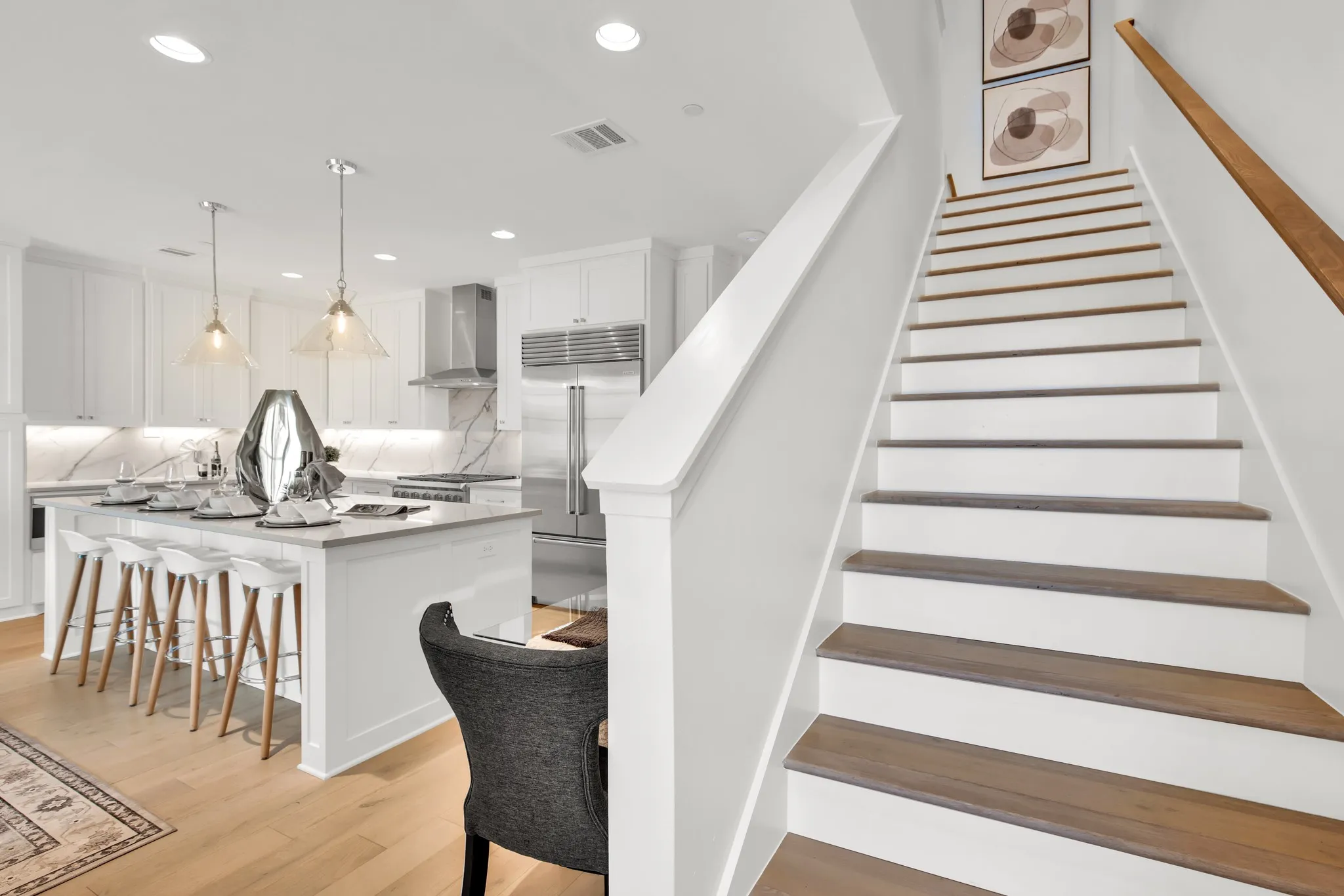 Stairway with recessed lighting and wood finished floors