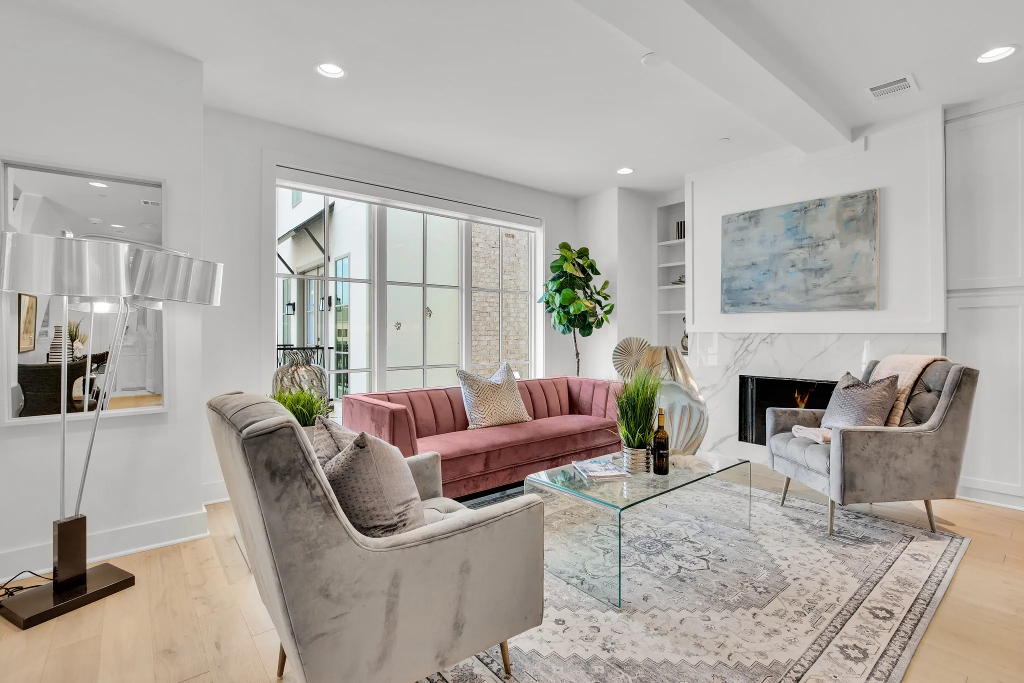 Living area featuring a premium fireplace, light wood finished floors, recessed lighting, beamed ceiling, and built in shelves