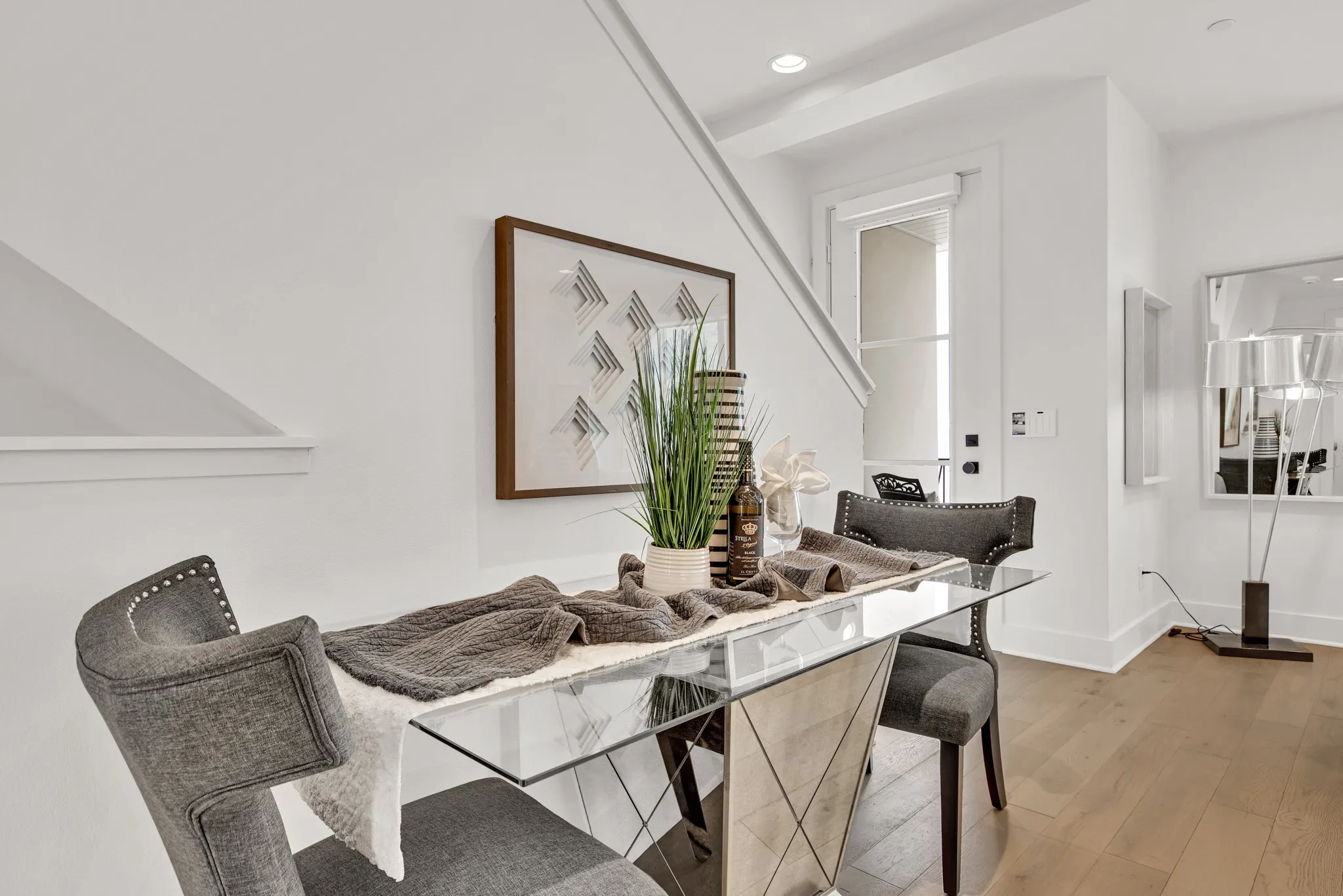 Dining room with light wood-style floors and recessed lighting