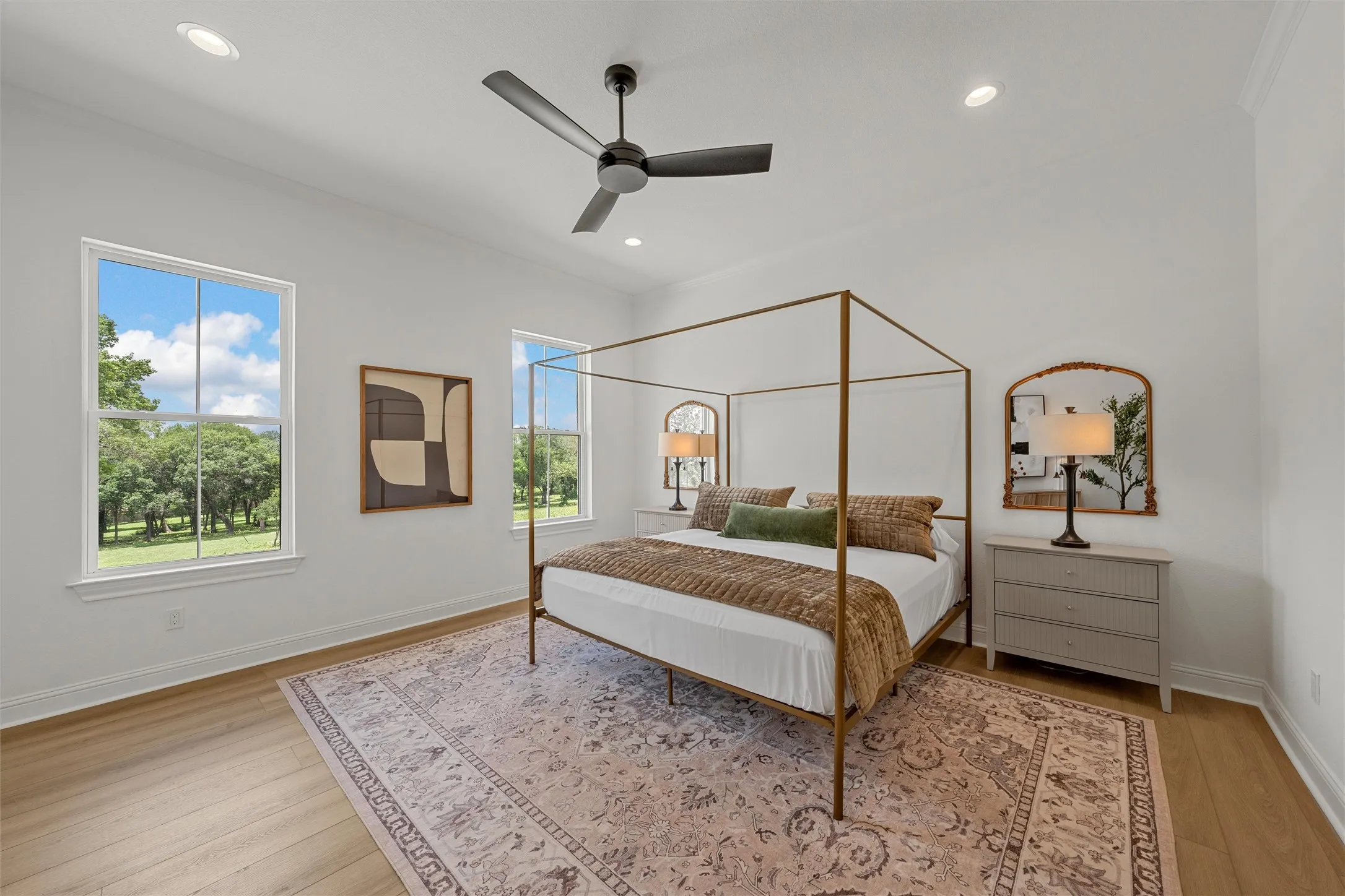 Spacious room featuring wood-finish flooring, recessed lighting, and a contemporary ceiling fan
