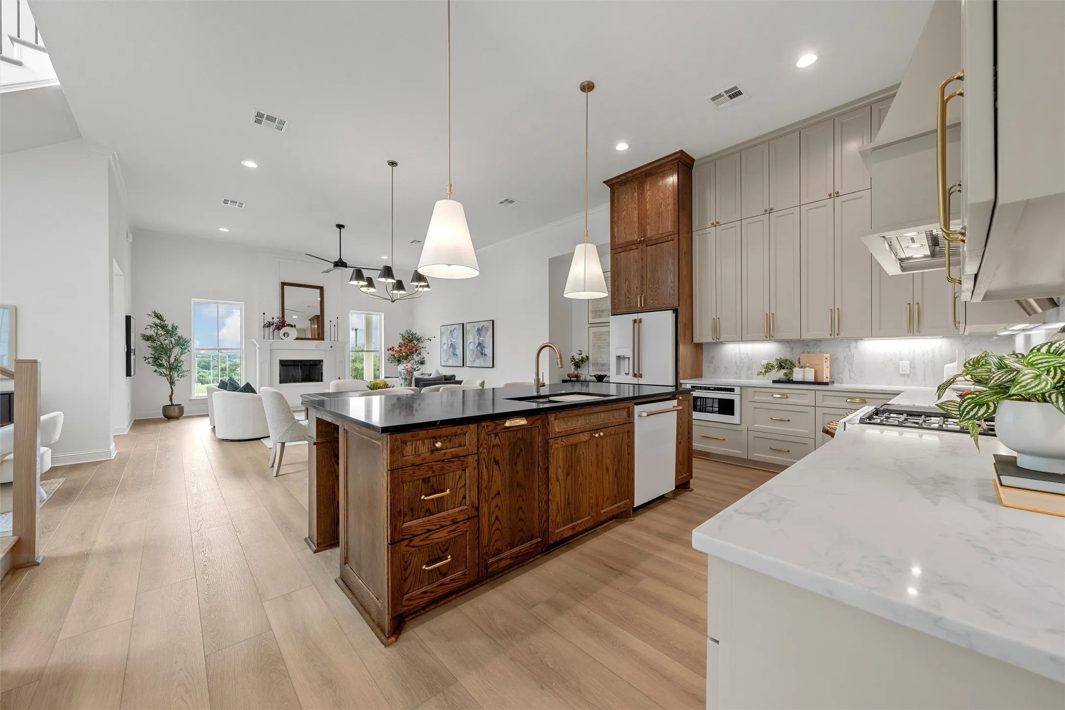 Expansive open-concept living space with wood-finish flooring