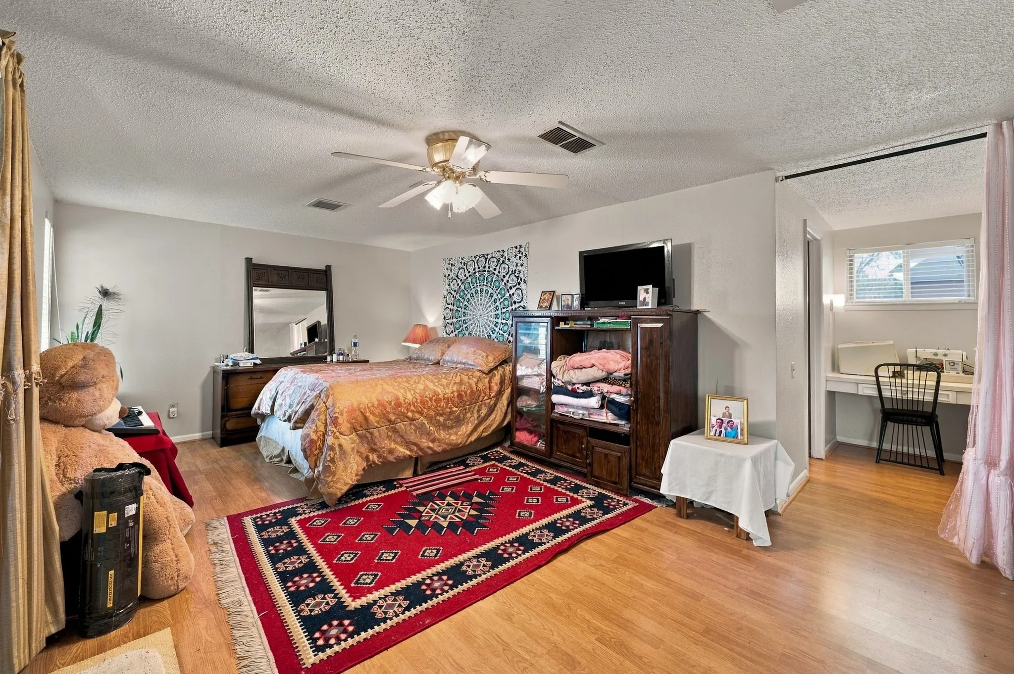 Spacious primary suite upstairs with extra room for a workstation