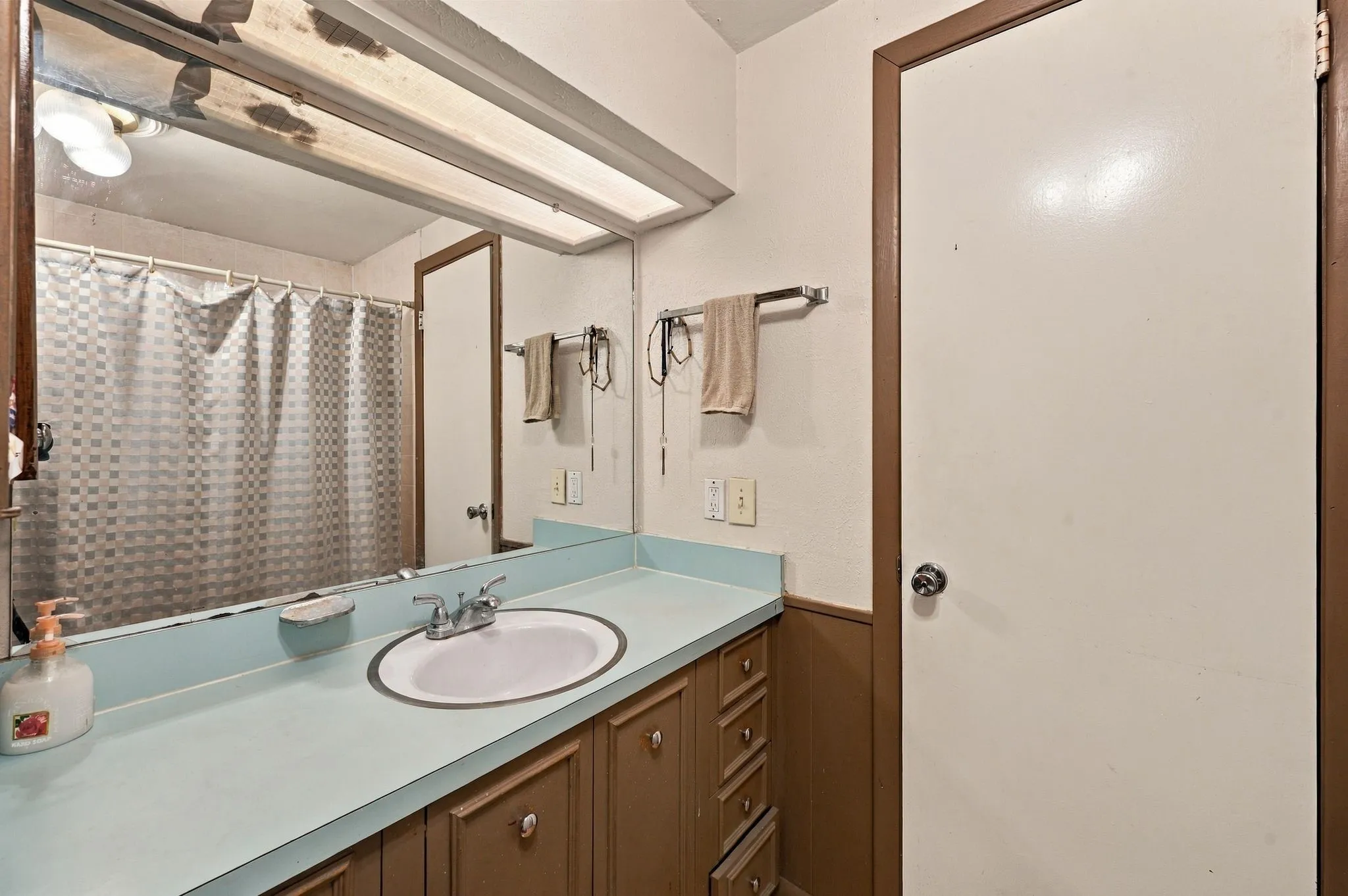 Primary bathroom with ample counter space, shower tub and primary walk-in closet.