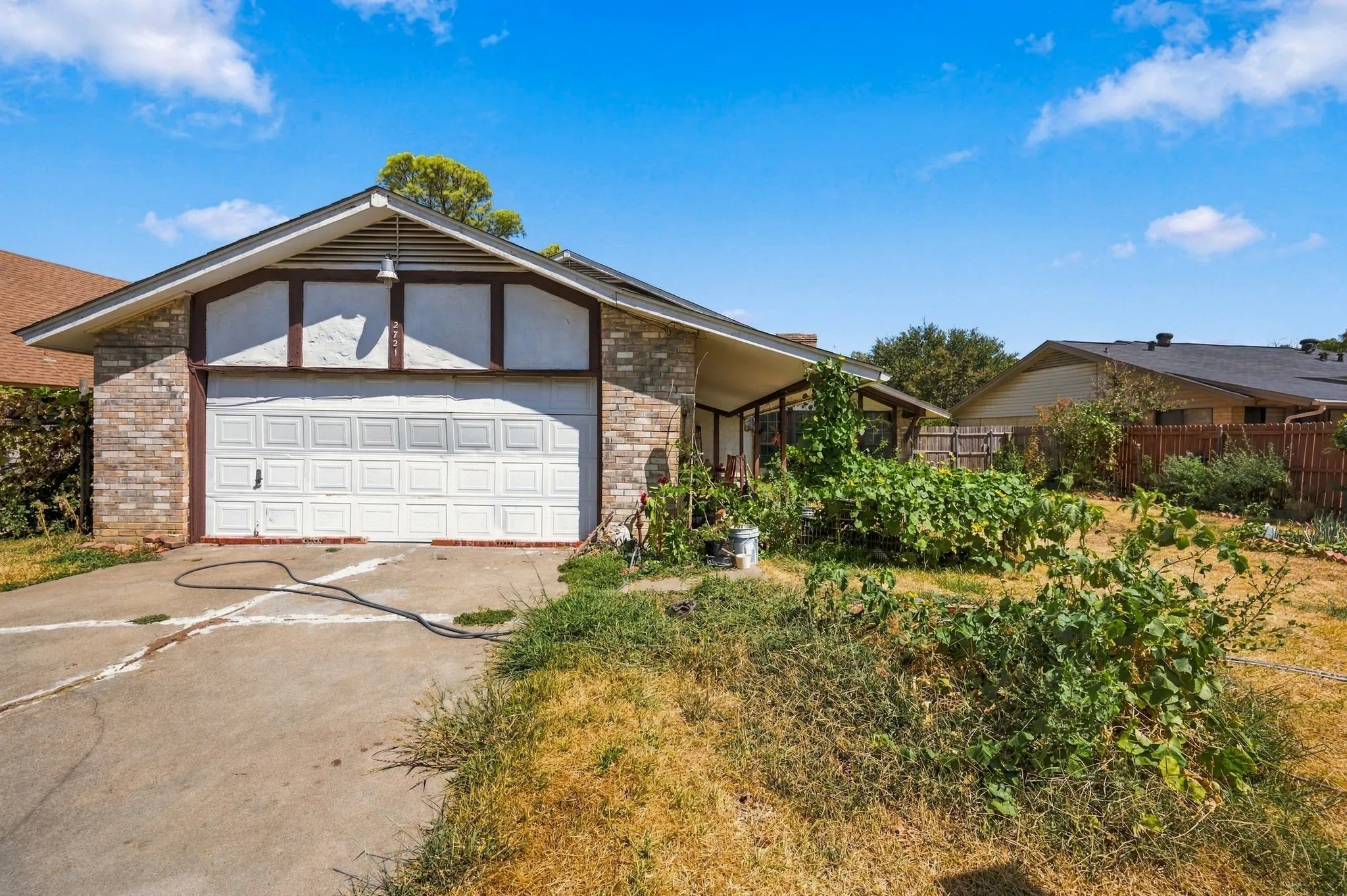 Back view of the property with the rear-entry garage and the back yard.
