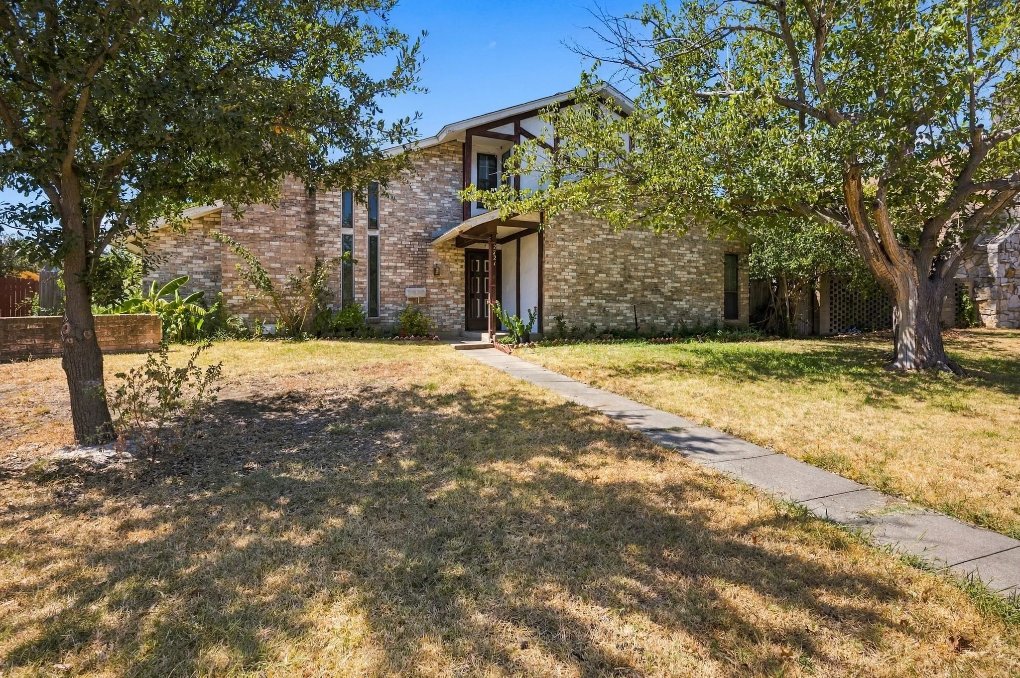 Front elevation with brick, stucco and siding.