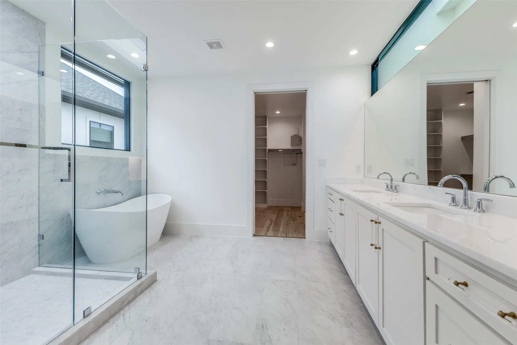 Primary Bath with dual sinks & marble countertops