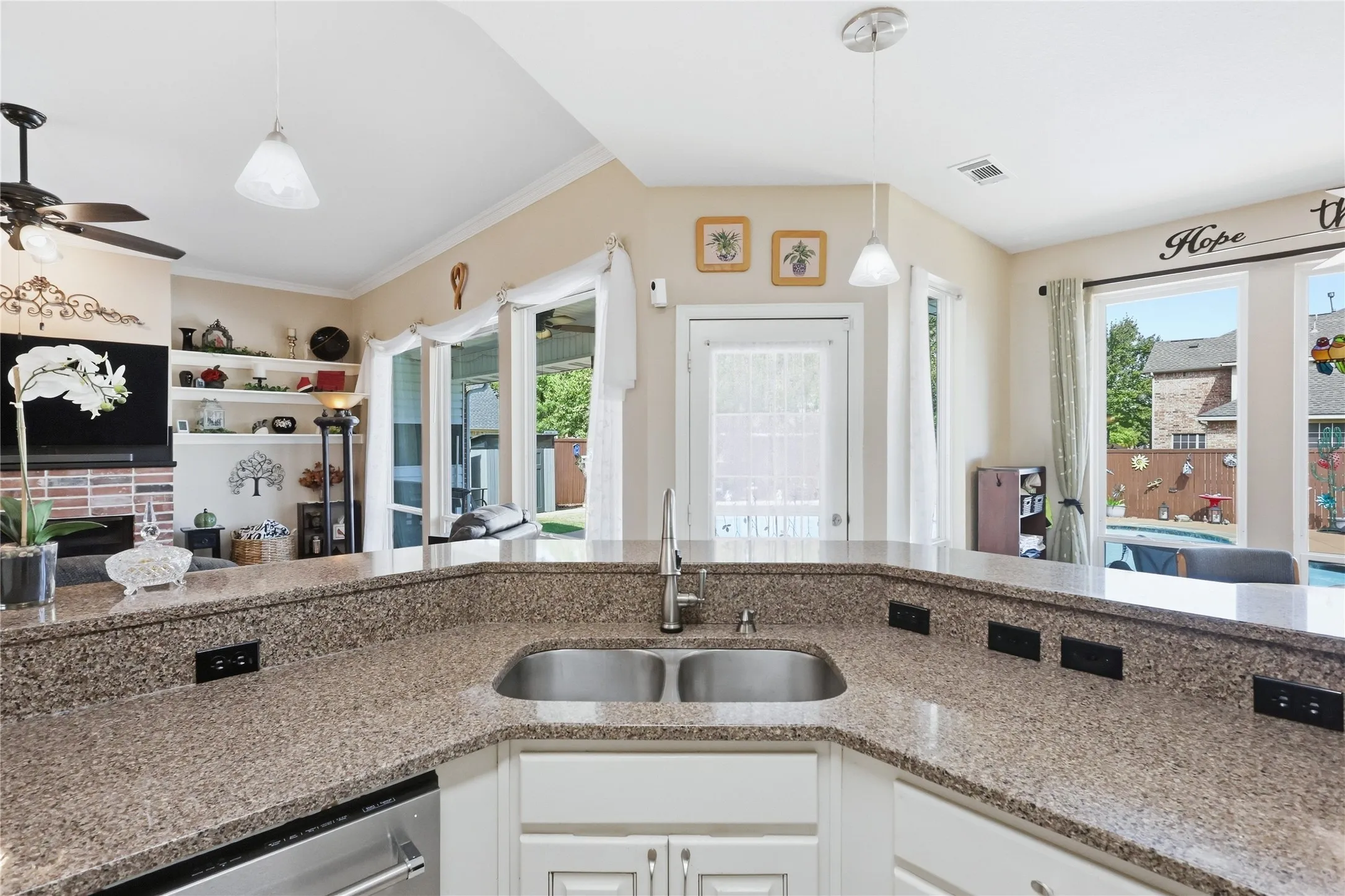 Kitchen featuring a double basin stainless steel sink, light-toned countertops, white cabinetry, and stainless steel appliances