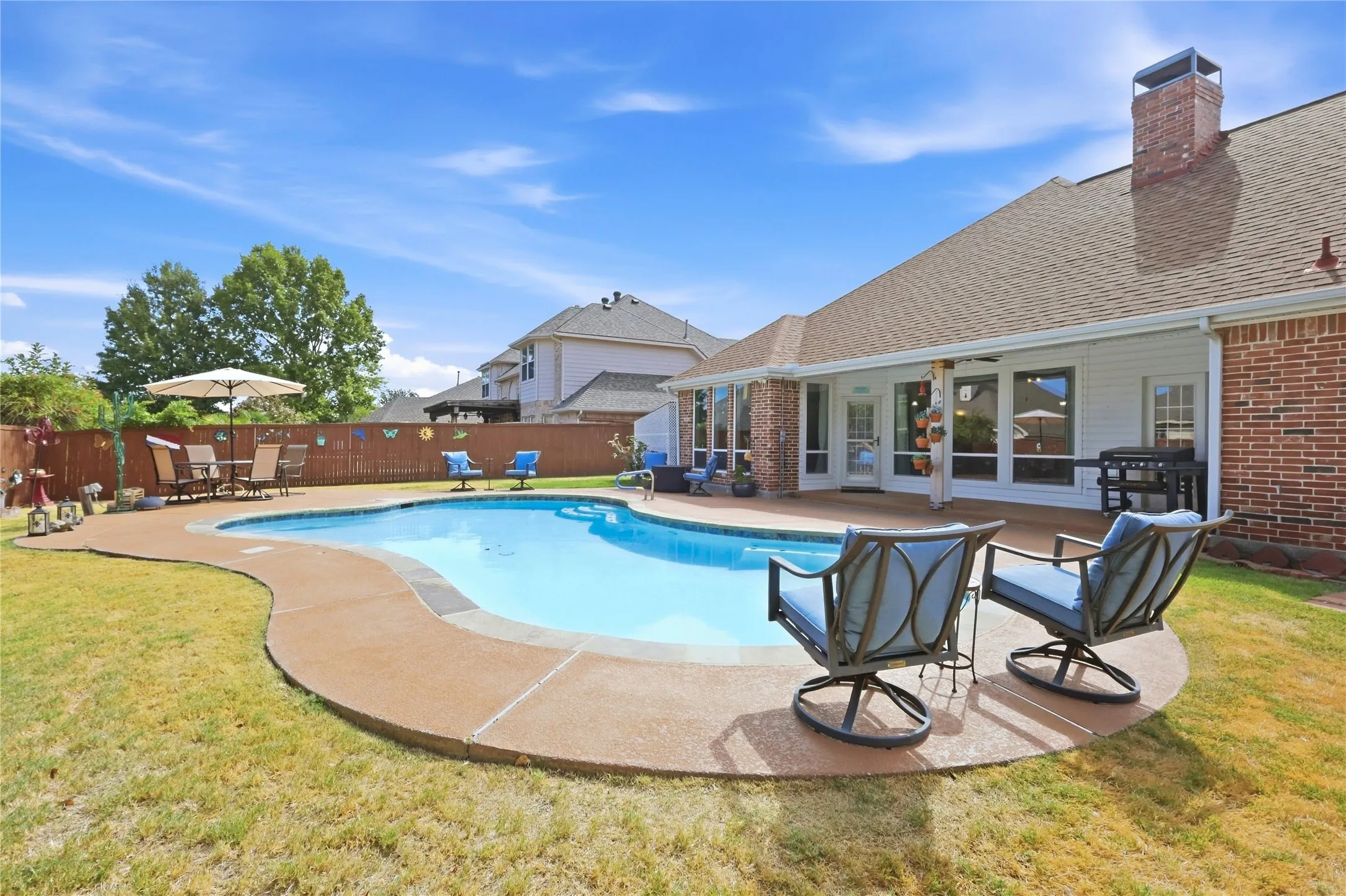 In-ground swimming pool with surrounding concrete decking