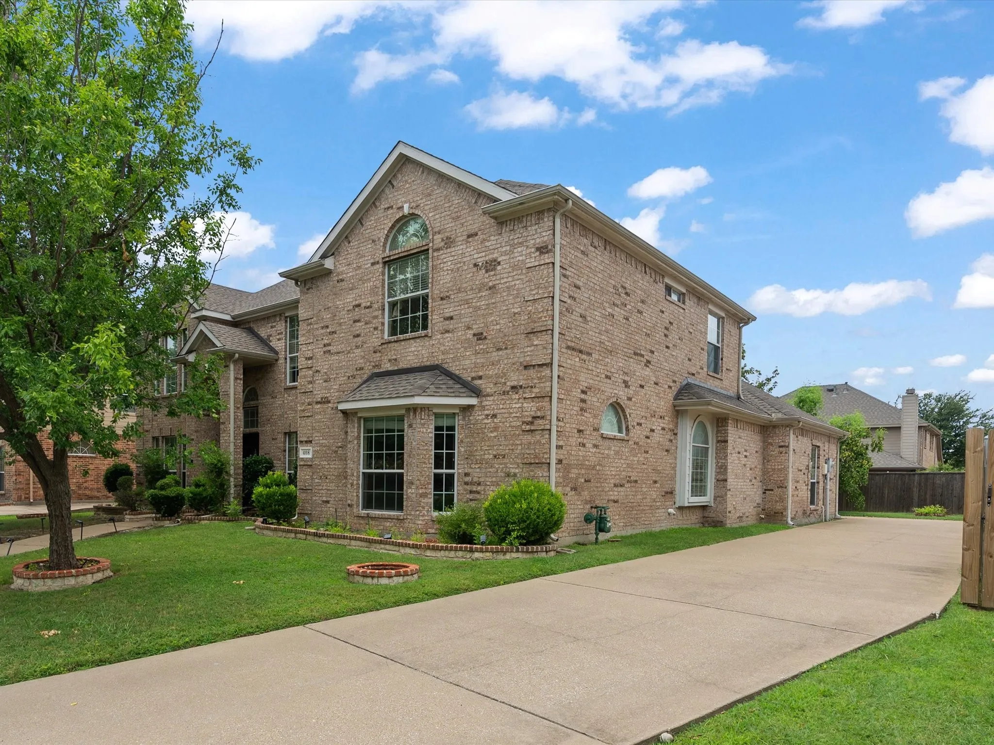 Brick-clad exterior with multiple gables and arched window details