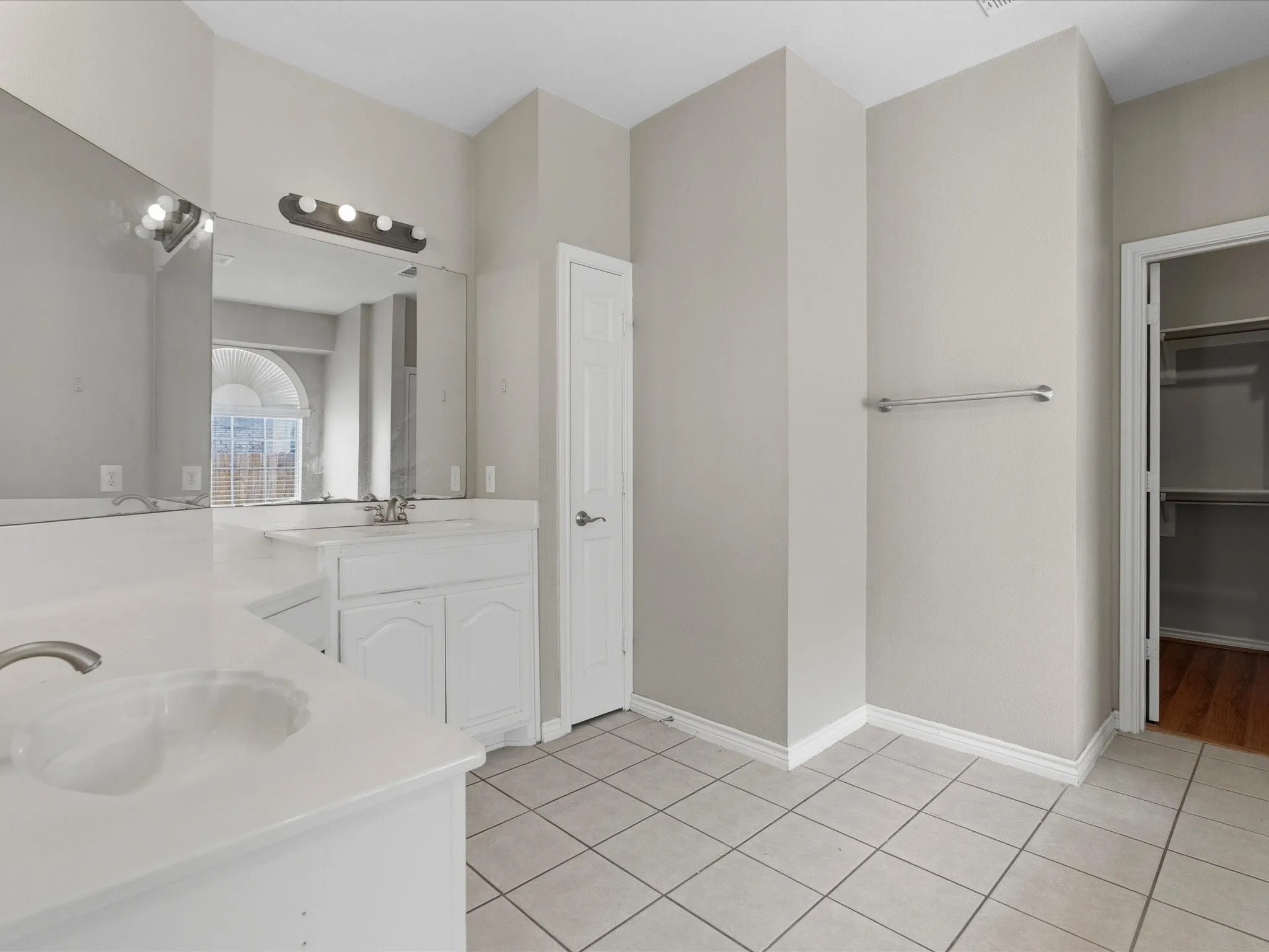 Dual vanity with white cabinetry and integrated sinks