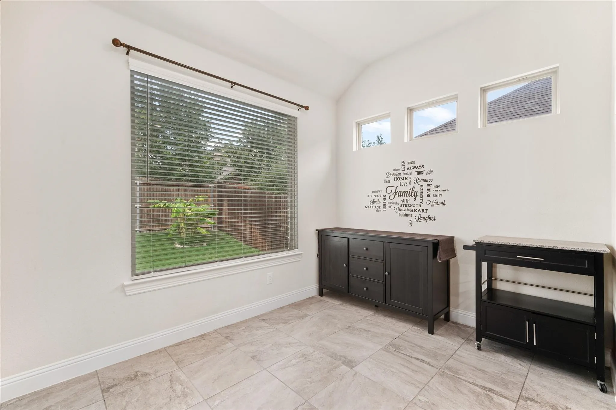 Recessed window with blinds and patterned drapes, ceiling fan with light fixture, light-toned carpet flooring, and white painted walls
