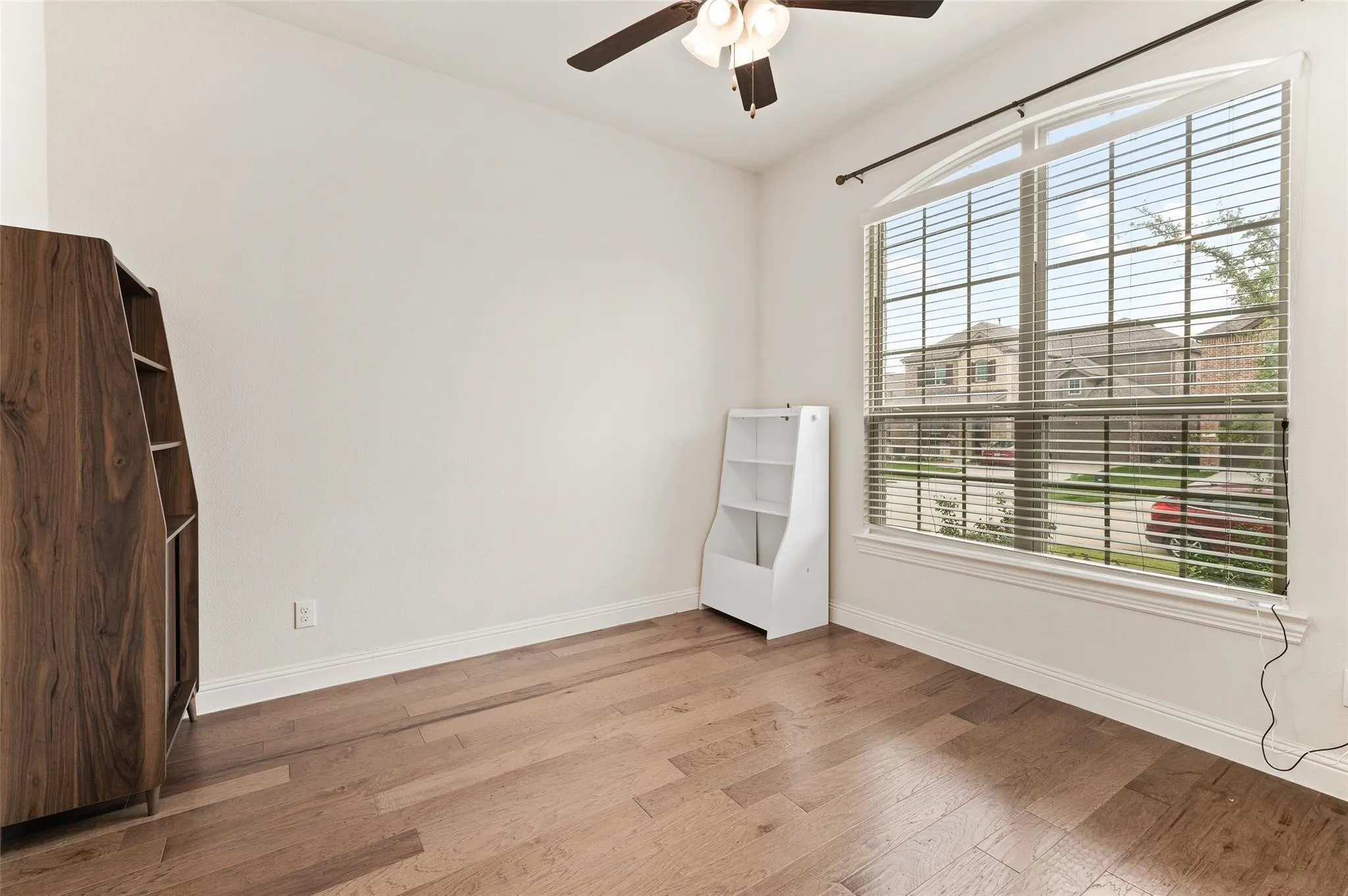 Wood-finish flooring with white baseboards