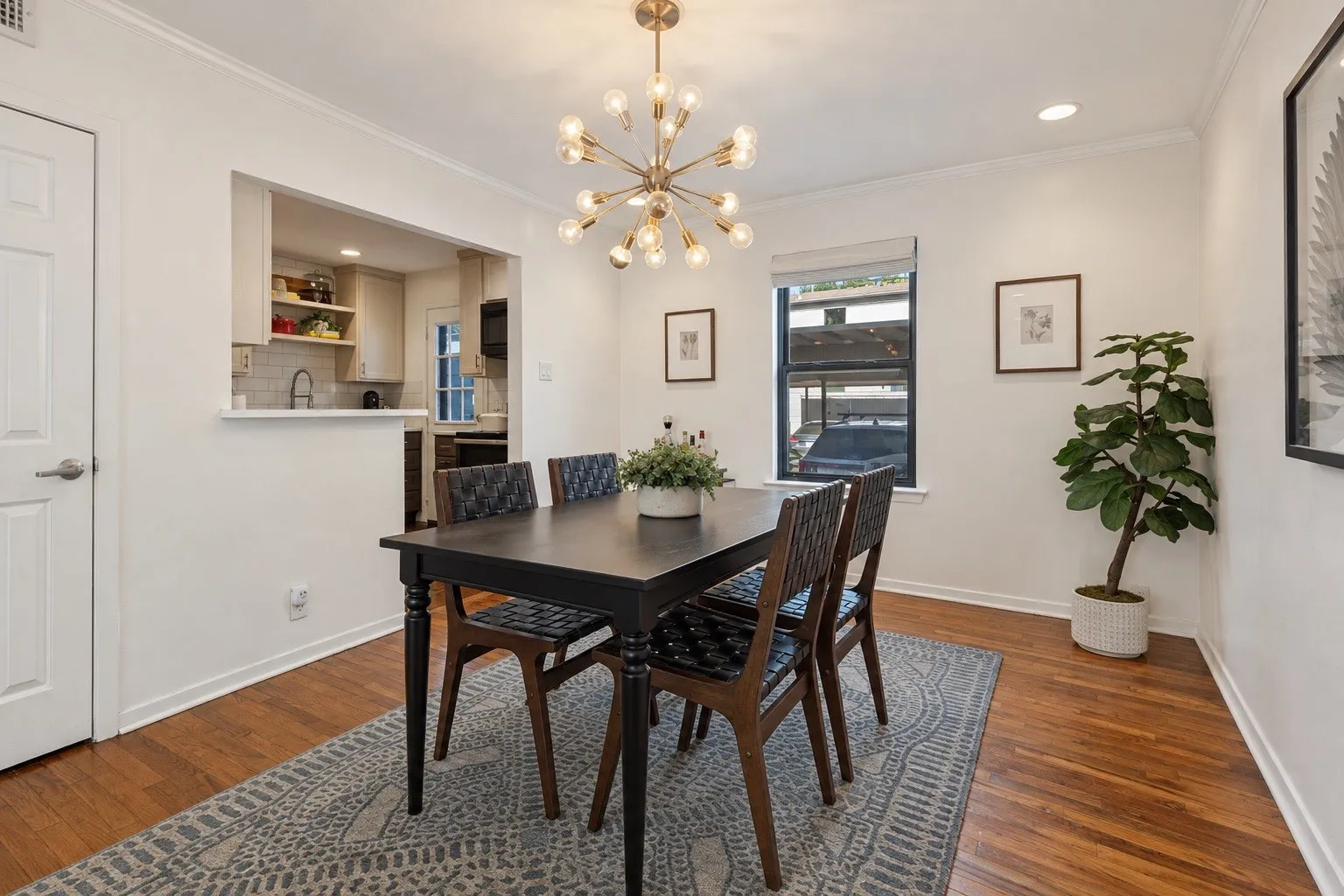 Wood-finish flooring, recessed lighting, and a modern sputnik chandelier