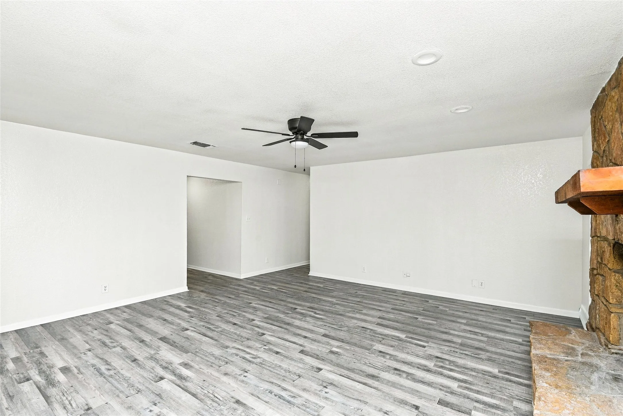 Wood-finish flooring, recessed lighting, and a ceiling fan