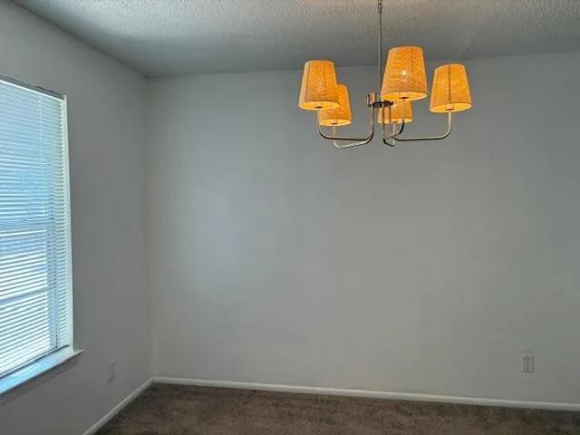 Dining Room Contemporary four-light chandelier with woven shades, window with horizontal blinds, and carpeted flooring