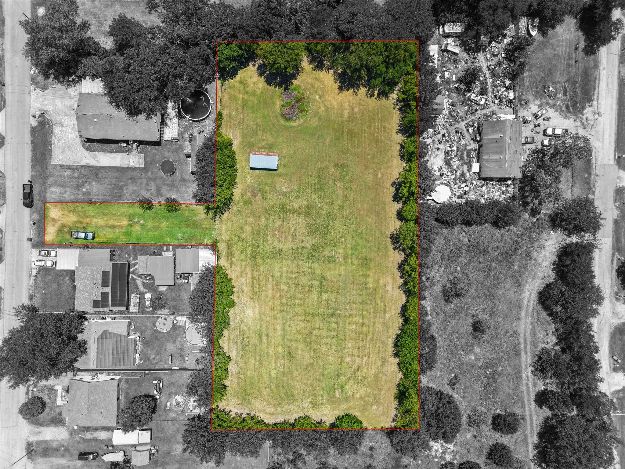 Expansive lot featuring mature perimeter trees and a clear, level ground