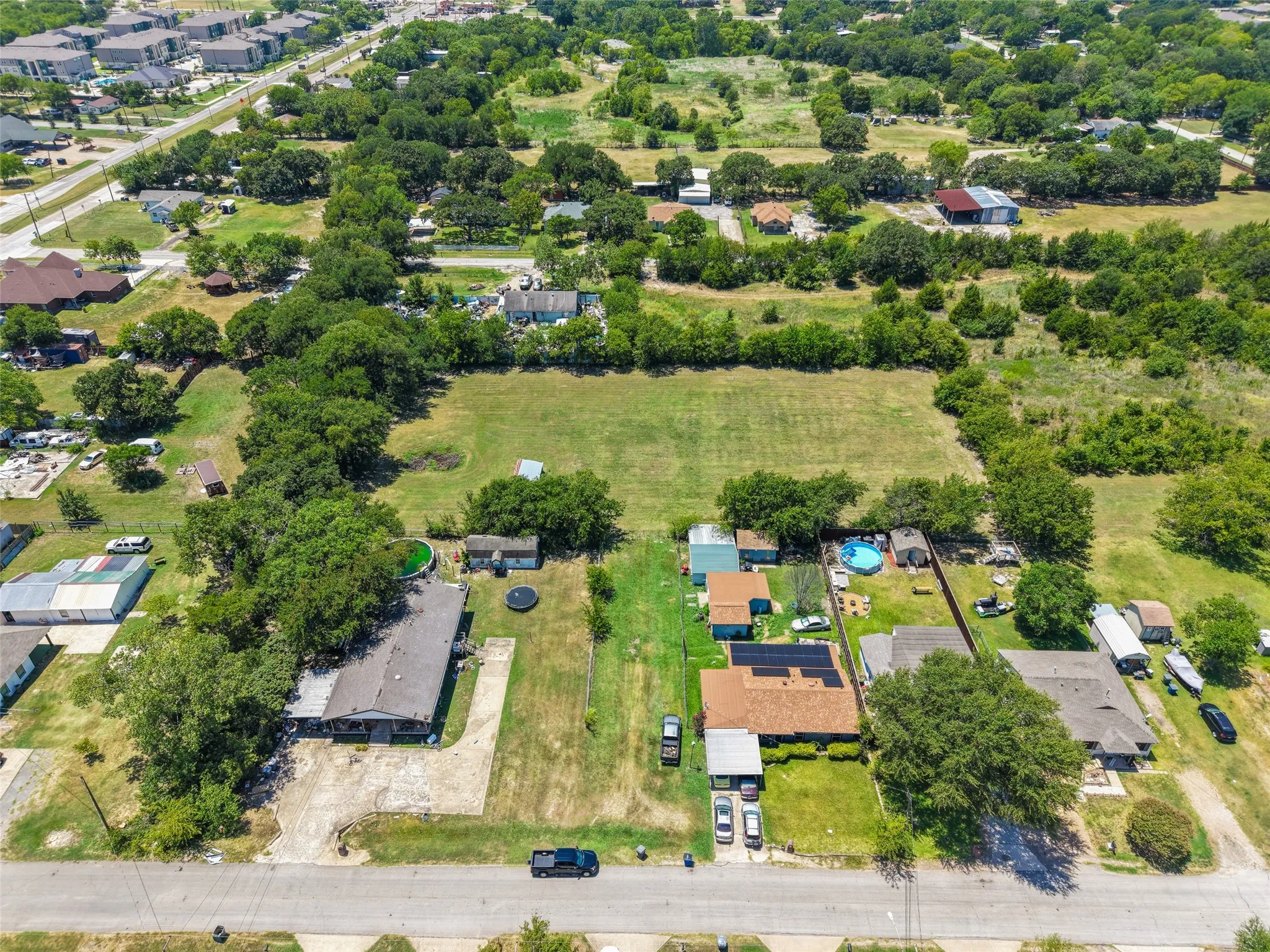 Aerial perspective highlighting expansive green spaces and established surrounding properties