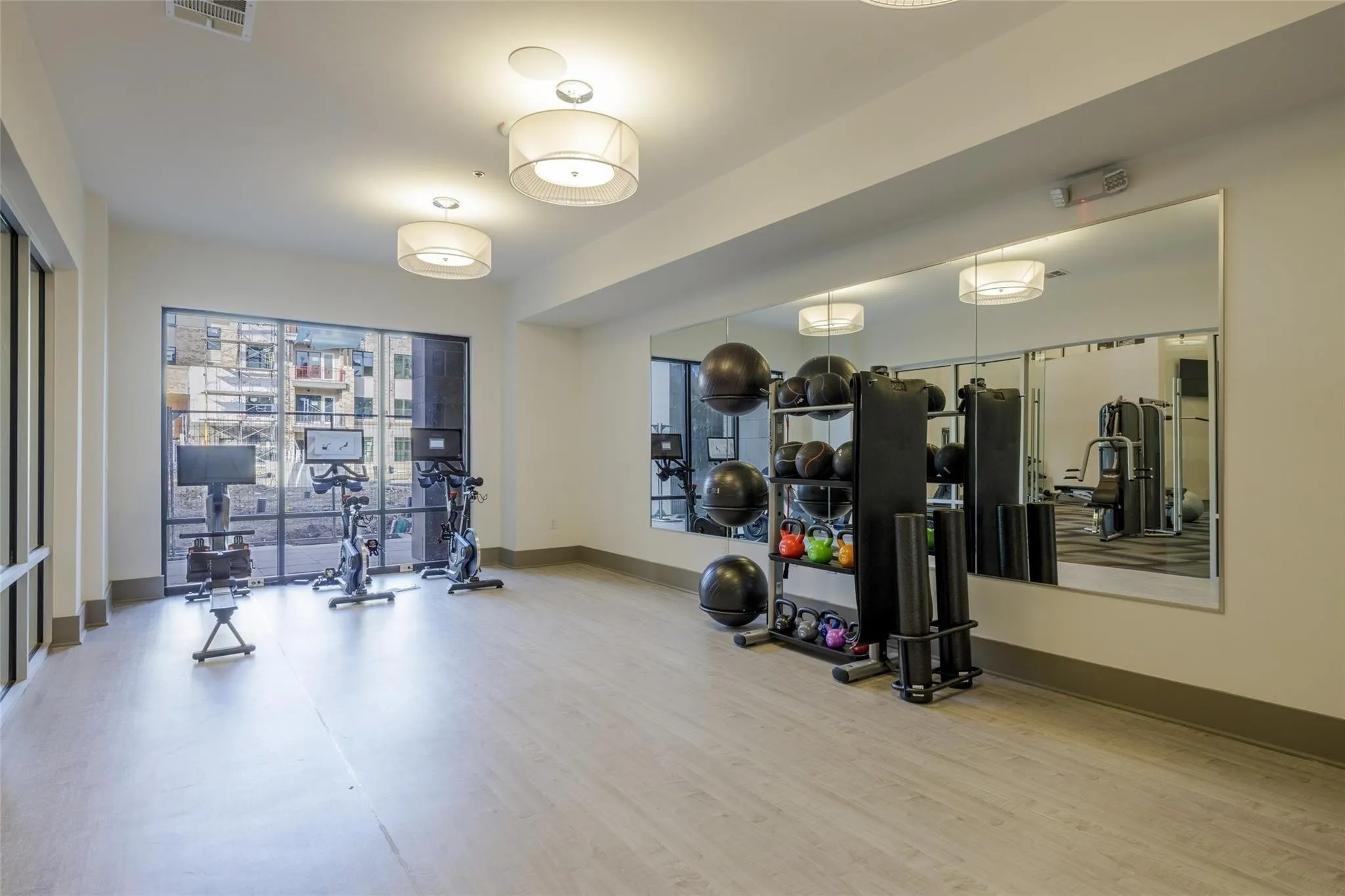 Dedicated fitness space with wood-finish flooring