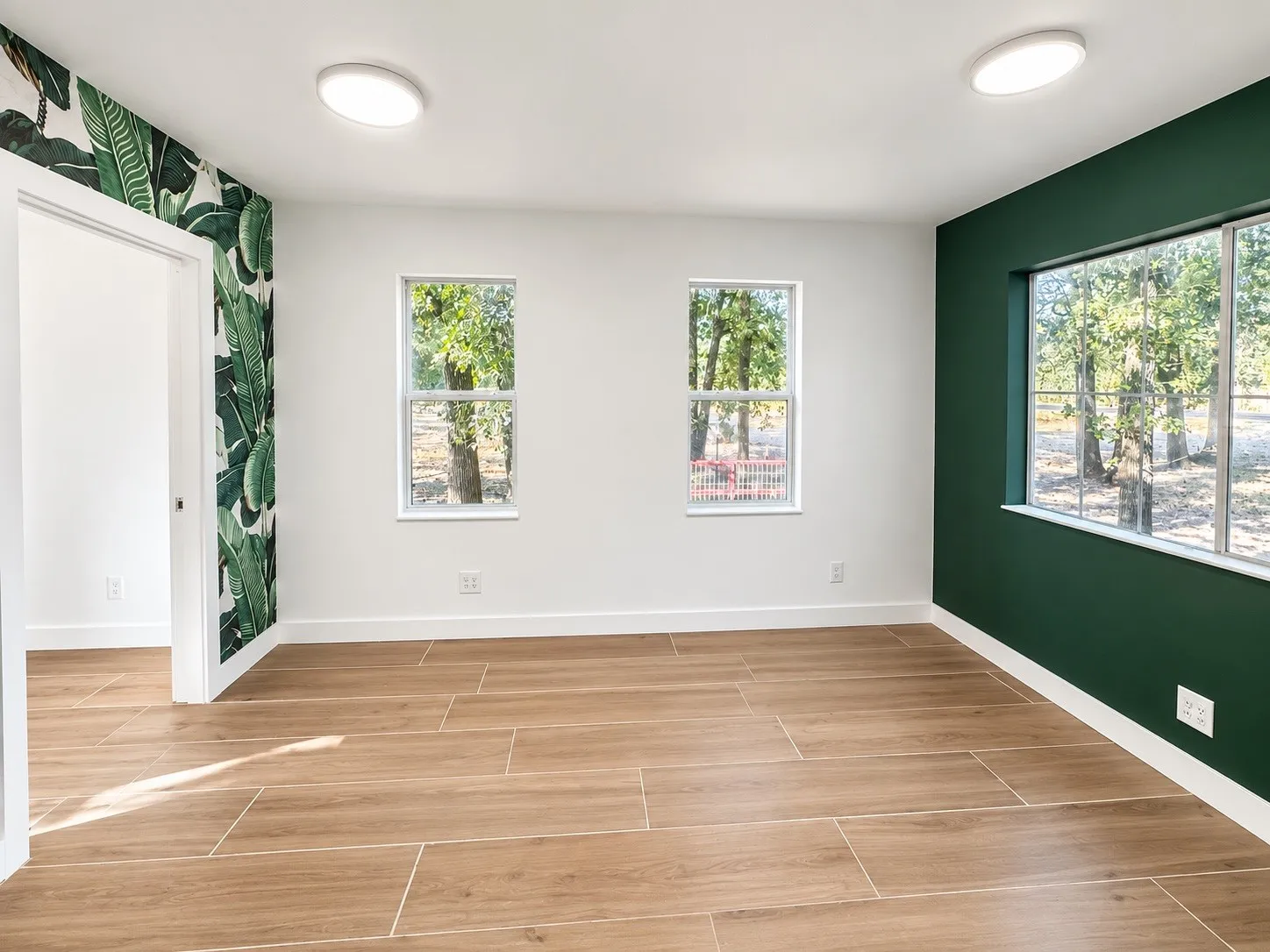 Wood-finish tile flooring complemented by white baseboards