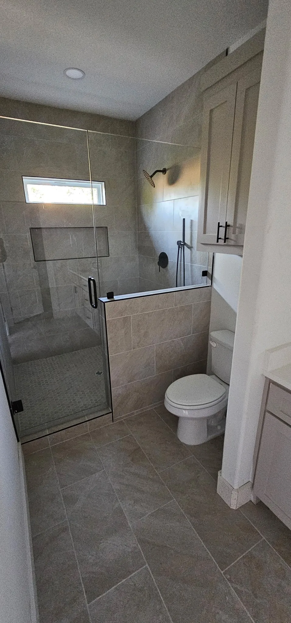 Full glass shower enclosure with matte black hardware