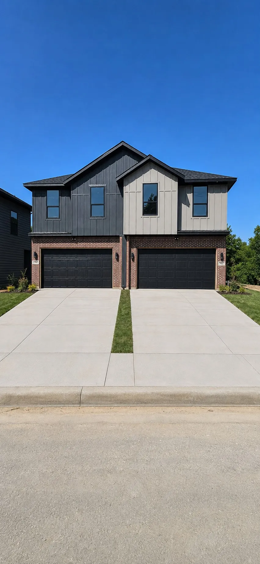 Modern duplex exterior with dark brick and vertical siding