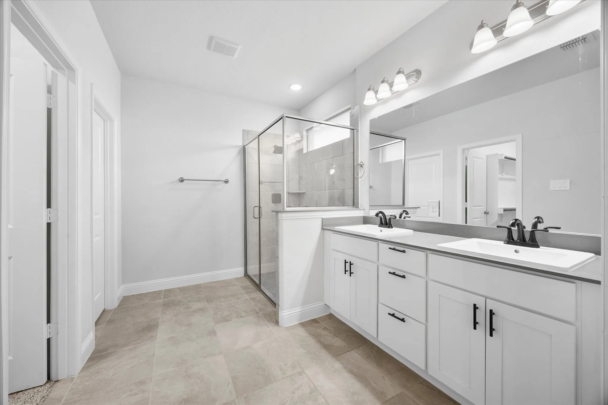 Spa style master bath includes his and her vanities