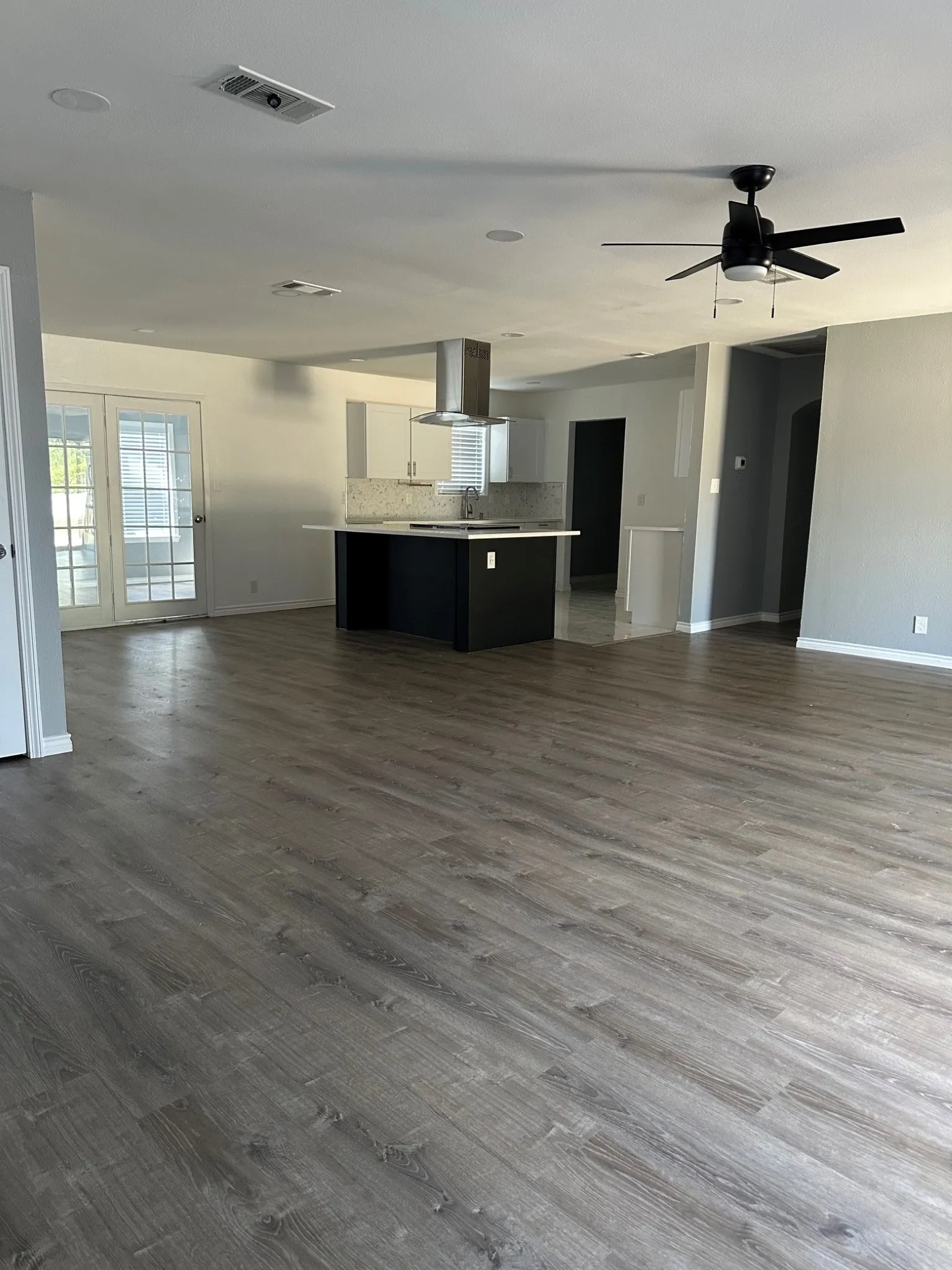 Open living area looking toward kitchen, breakfast room and office area