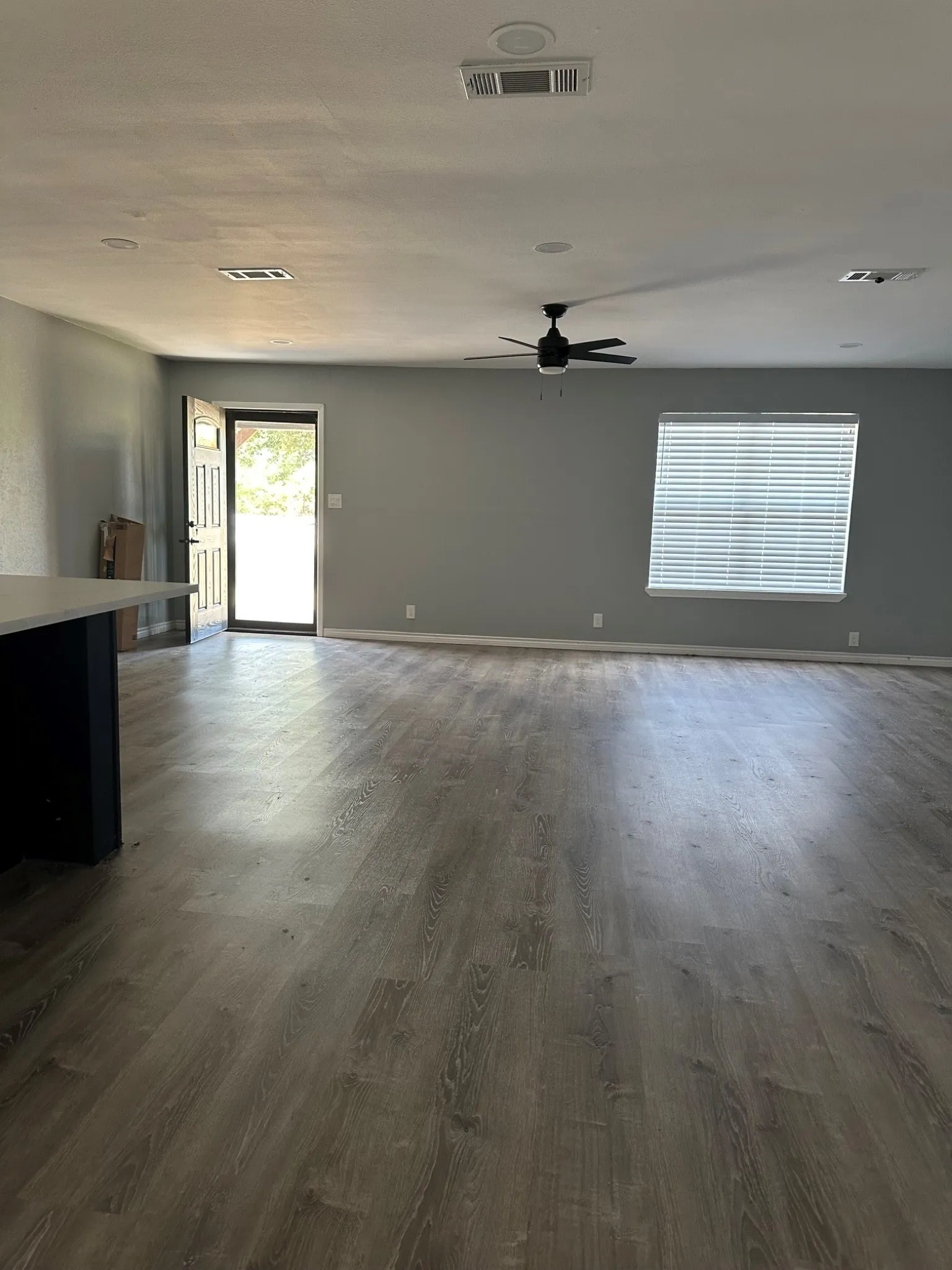 Open living area of den and  breakfast room from french doors to office