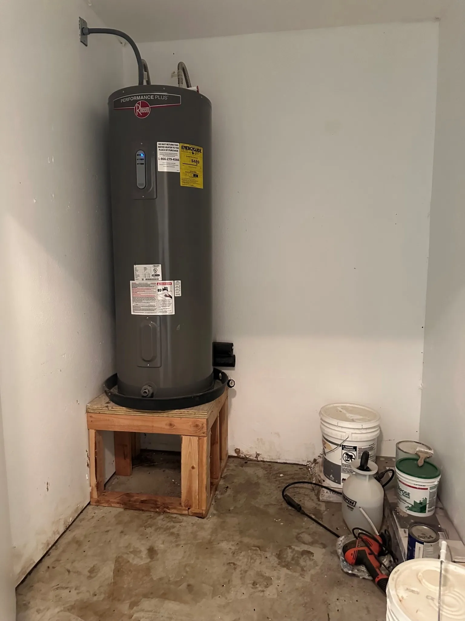 Water heater in storage room in garage