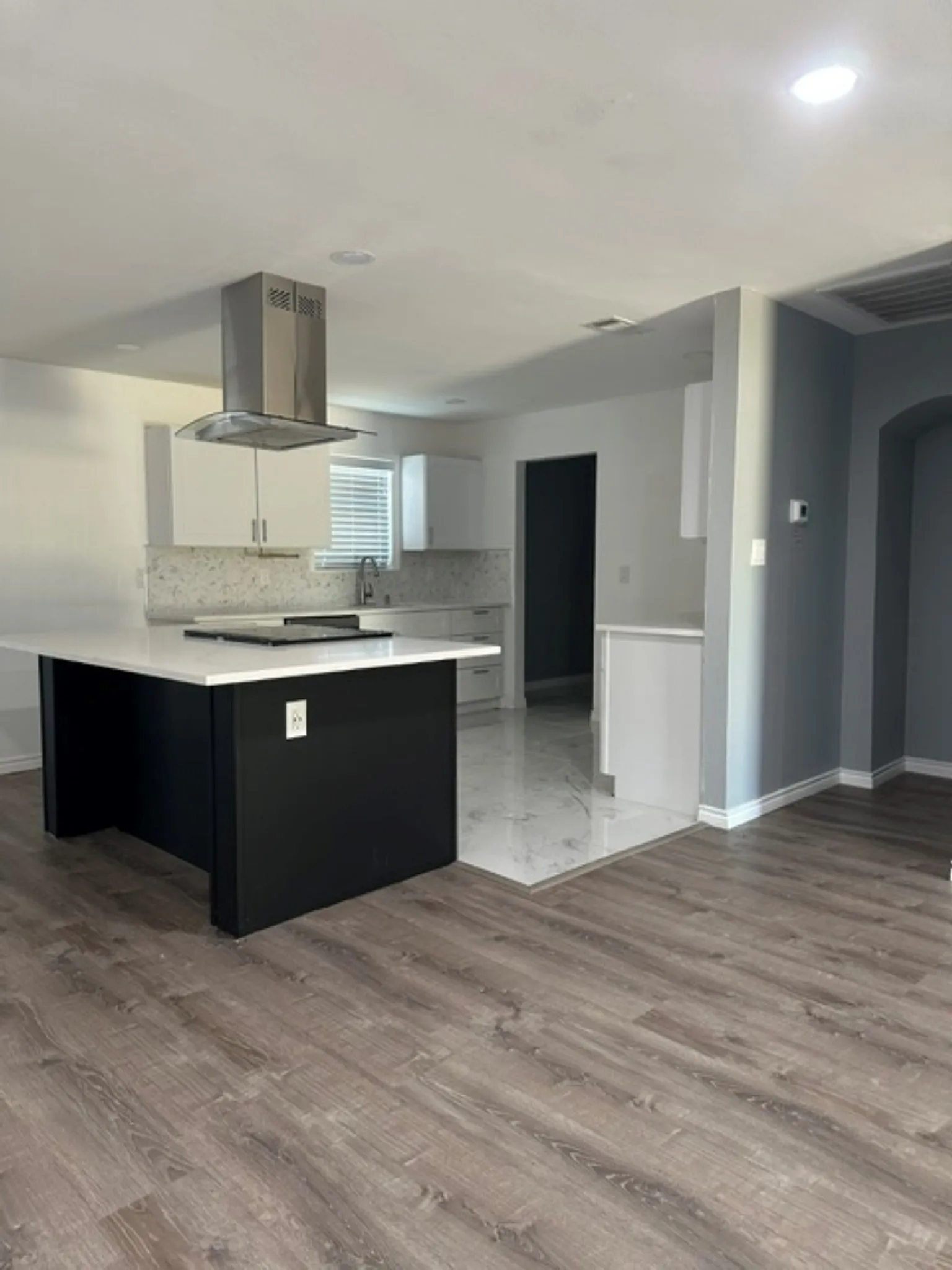 View of kitchen and hallway to primary bedroom