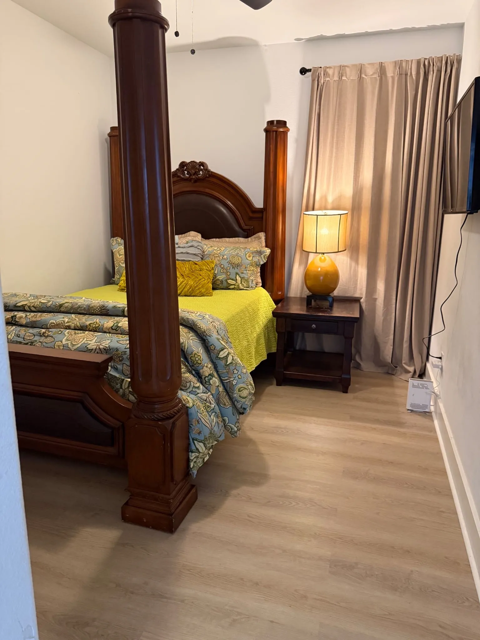 Light wood-finish flooring with white baseboards