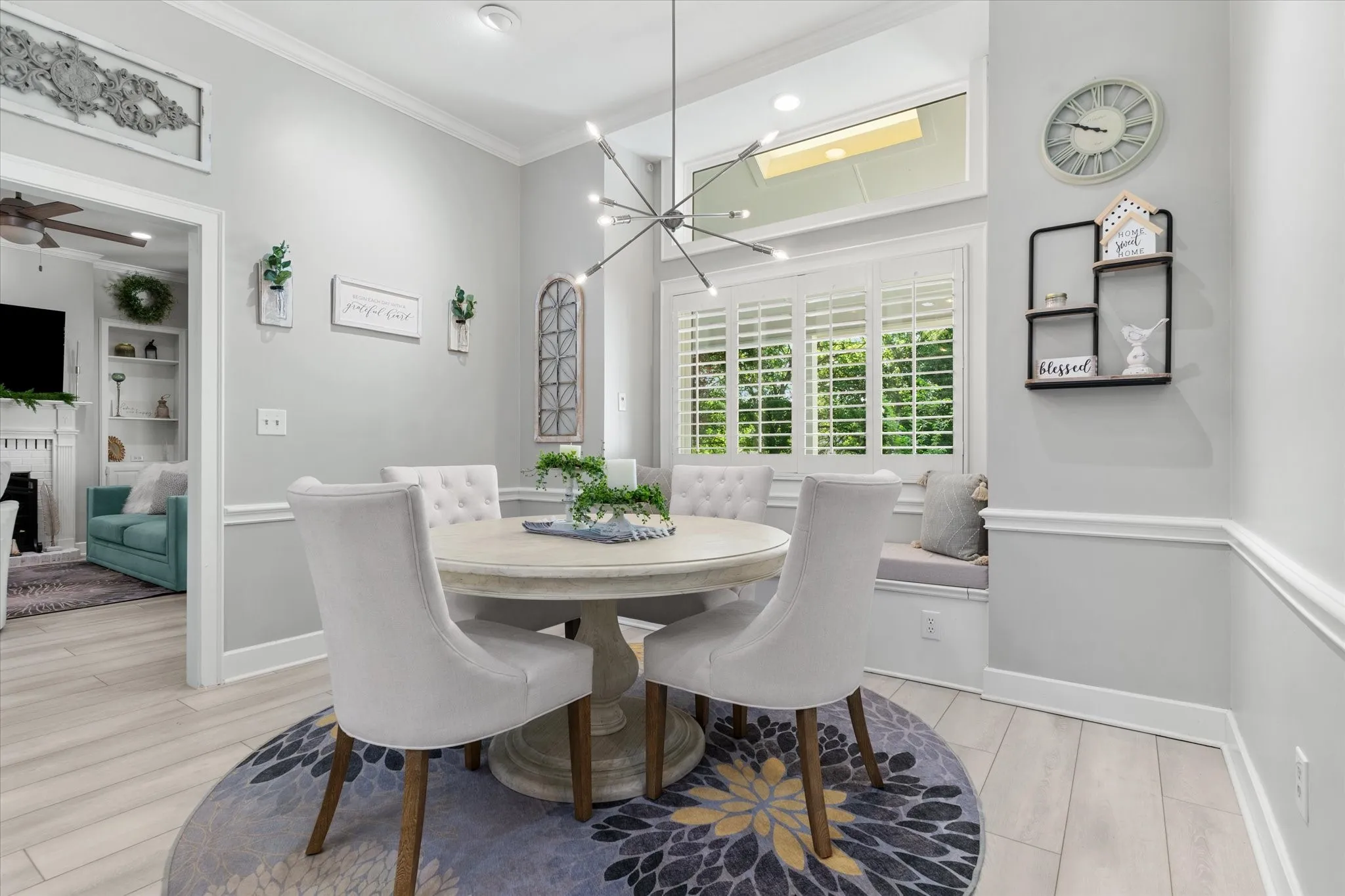 Wood-finish flooring with crisp white crown molding and chair rail