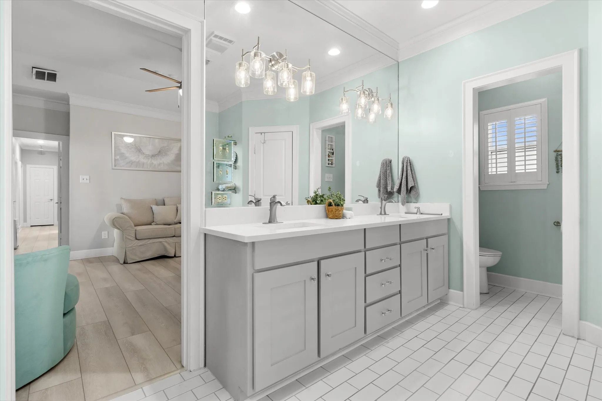 Dual vanity with undermount sinks, wood-finish cabinetry, and a full-width mirror