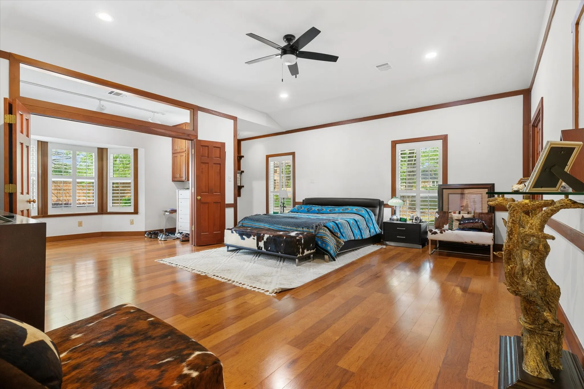 Hardwood flooring throughout, vaulted ceiling, recessed lighting, ceiling fan, and plantation shutters