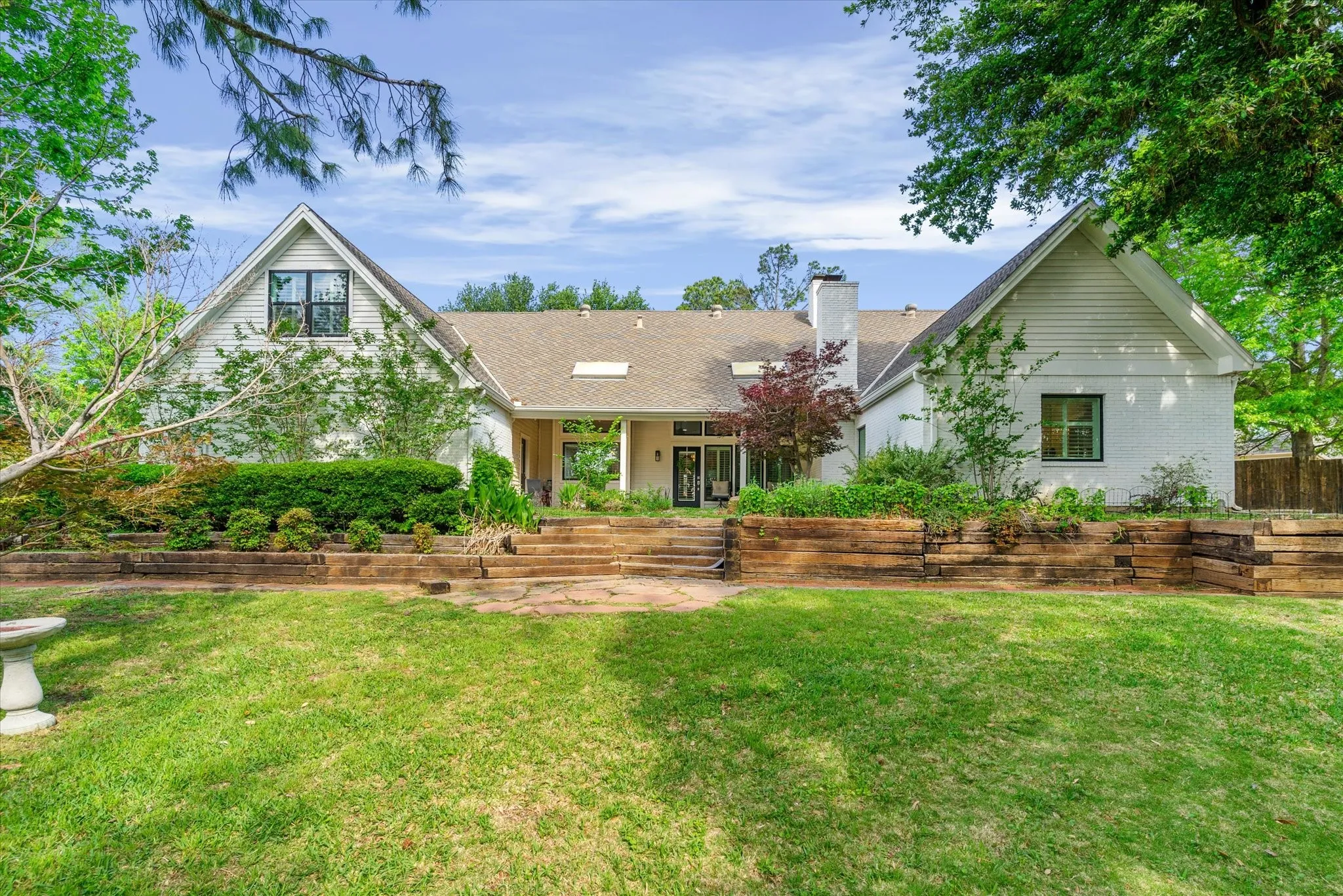 White exterior with gabled rooflines and dark-trimmed windows