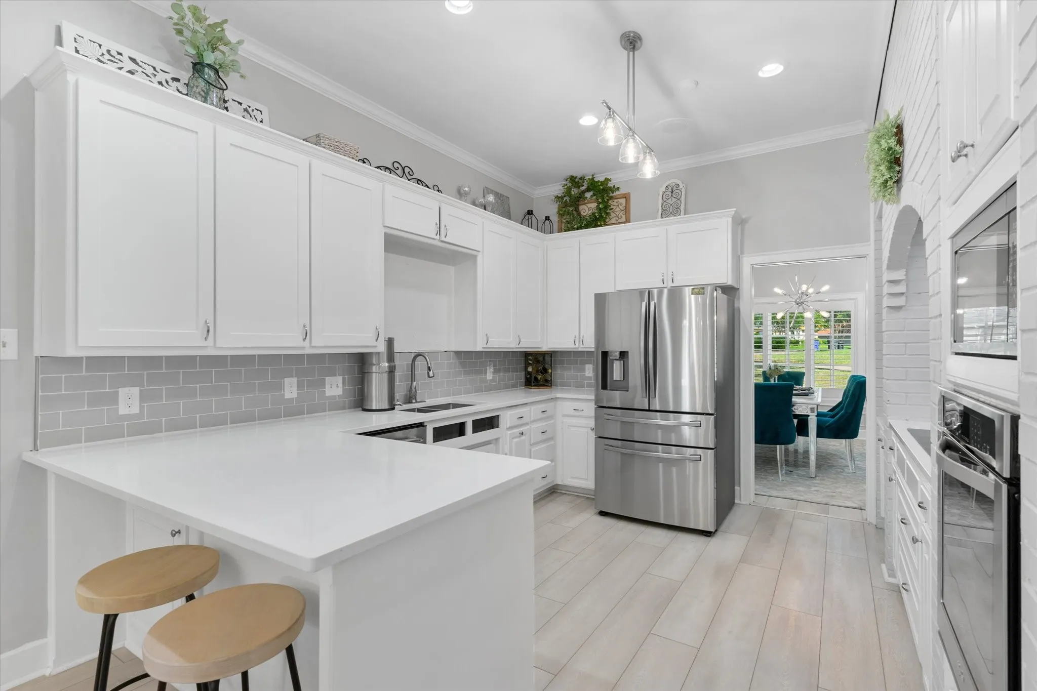 White shaker cabinetry with a light gray subway tile backsplash