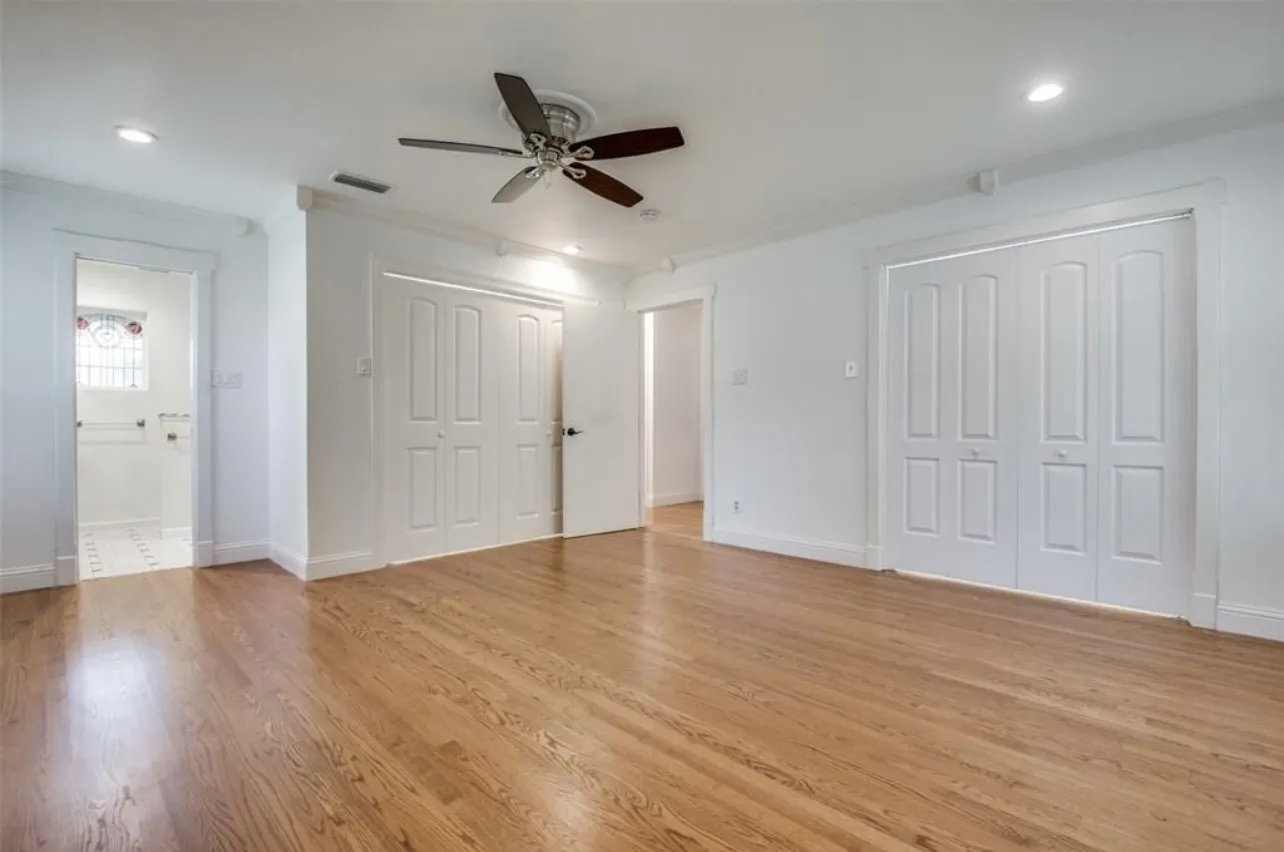 Hardwood flooring, recessed lighting, ceiling fan, and white bi-fold closet doors