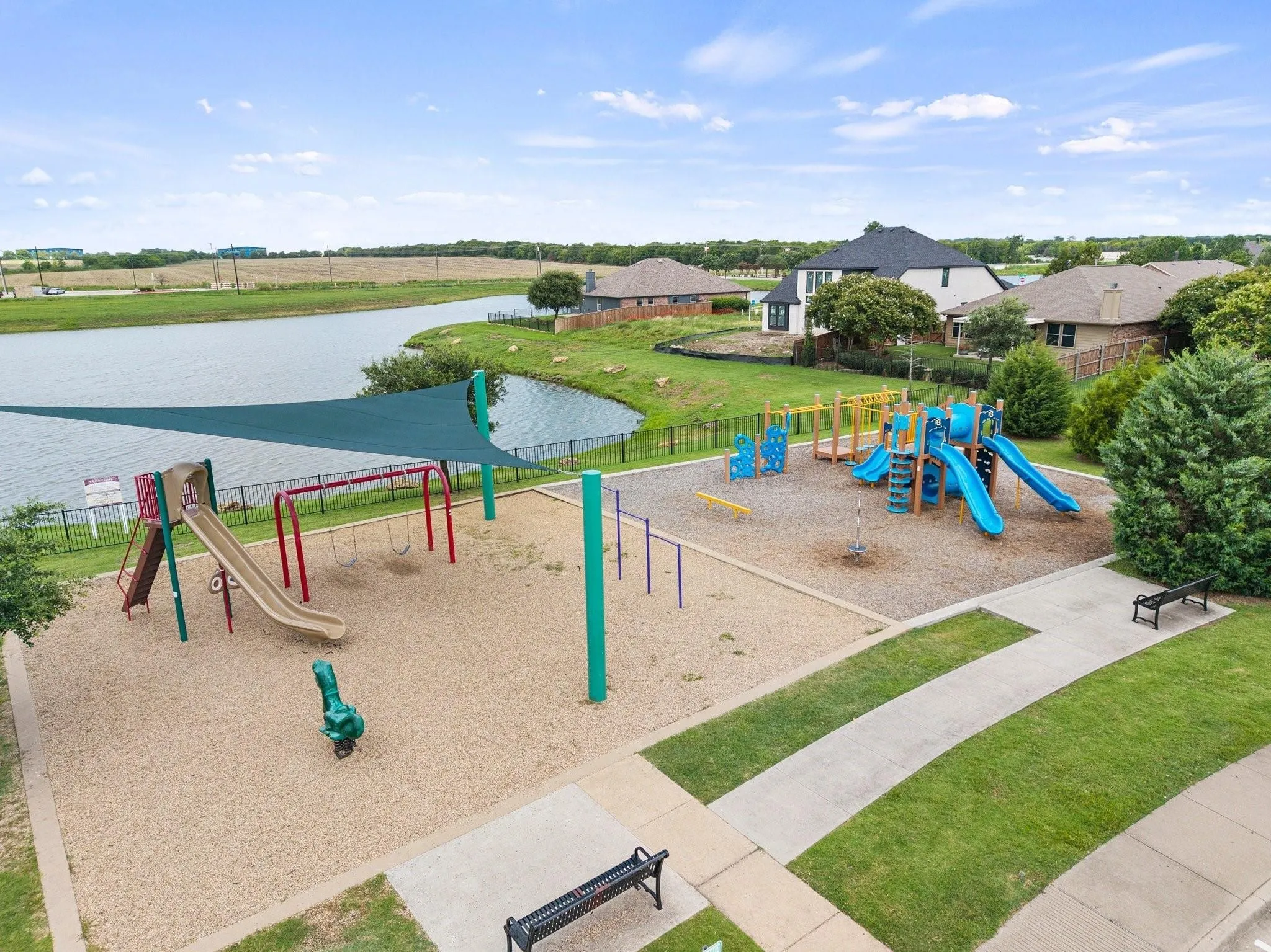 Community playground featuring multiple slides, swings, and climbing structures