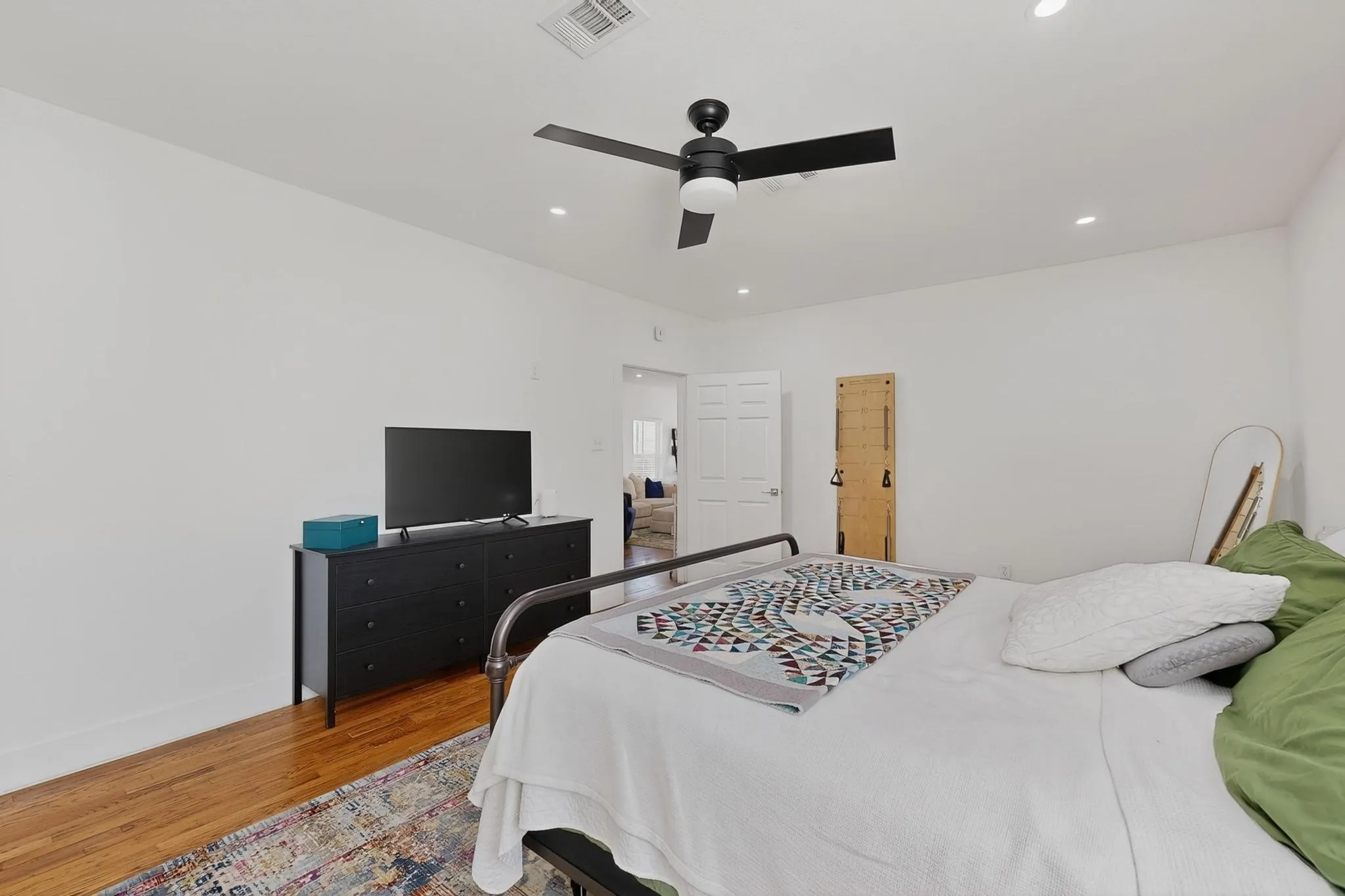 Hardwood flooring, recessed lighting, and a ceiling fan with integrated lighting