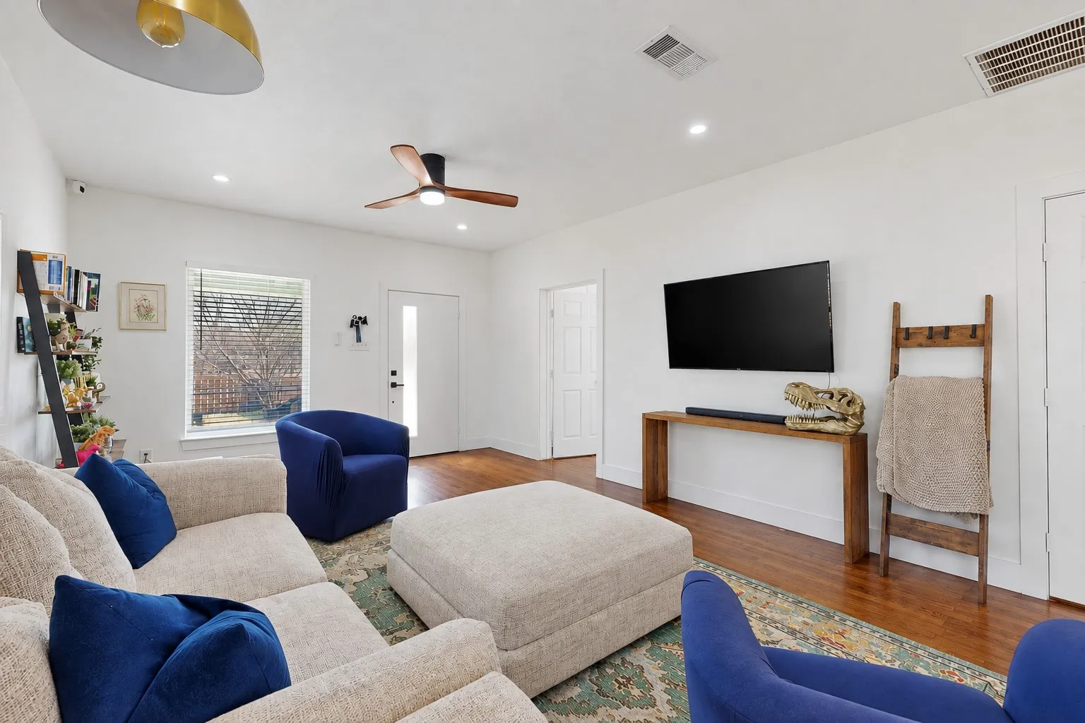 Hardwood flooring, recessed lighting, and a contemporary ceiling fan