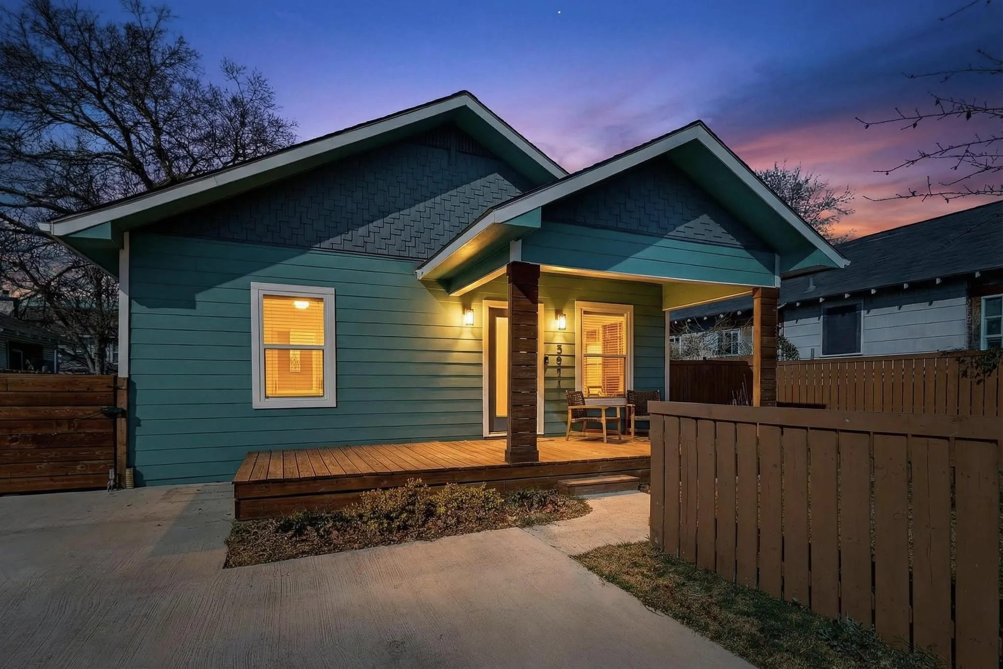 Exterior featuring horizontal siding, a covered porch with wood columns, a wood deck, and an architectural shingle roof
