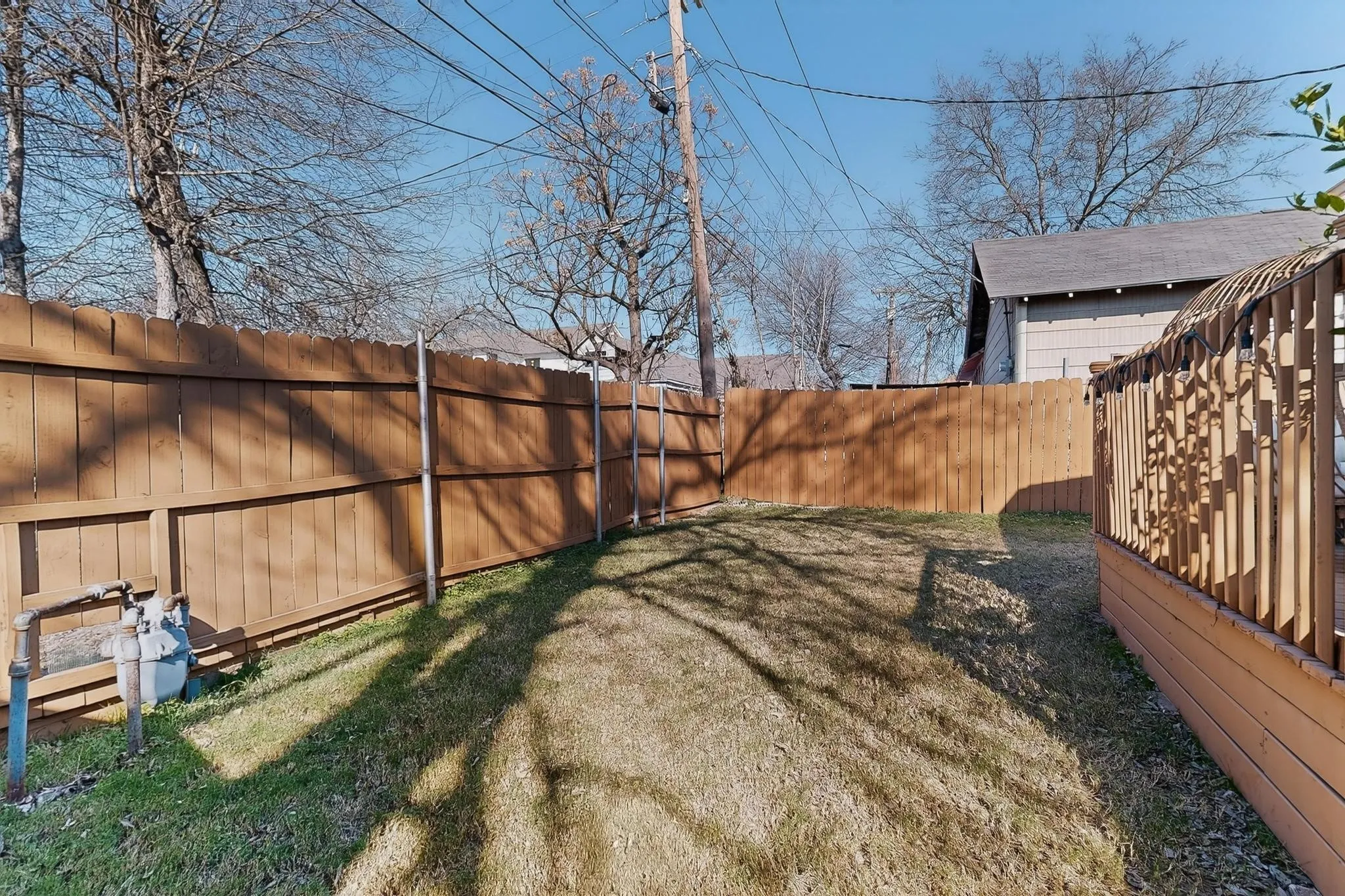 Wood-panel fencing enclosing a yard with grass