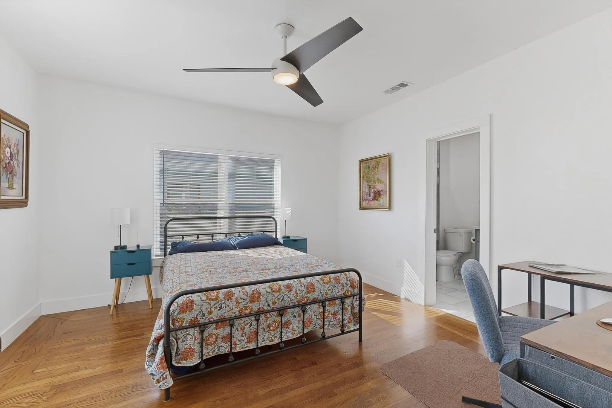 Vaulted ceiling with a ceiling fan, wood-finish flooring, window with blinds, and white interior walls
