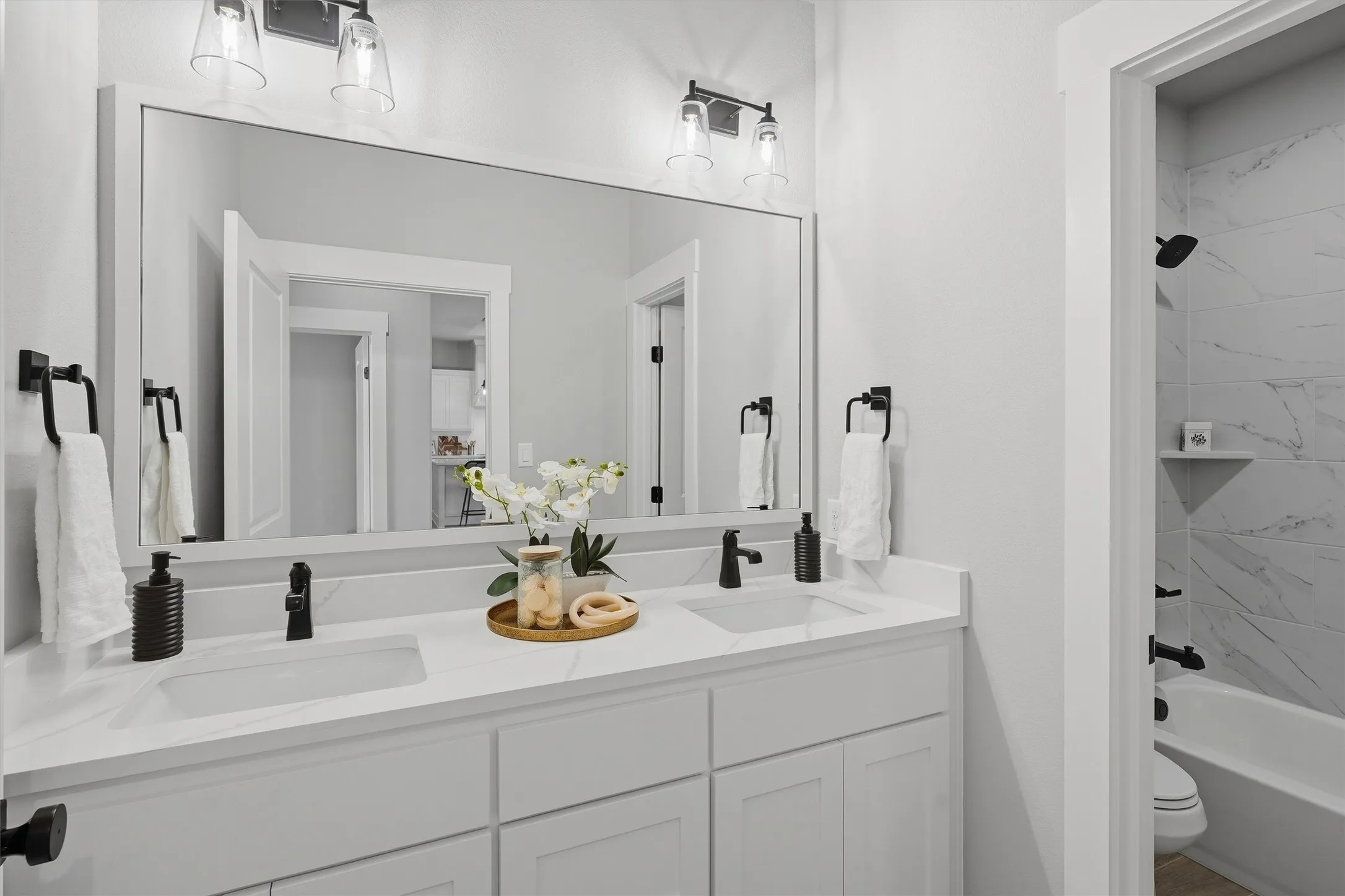 Dual vanity with undermount sinks and matte black fixtures