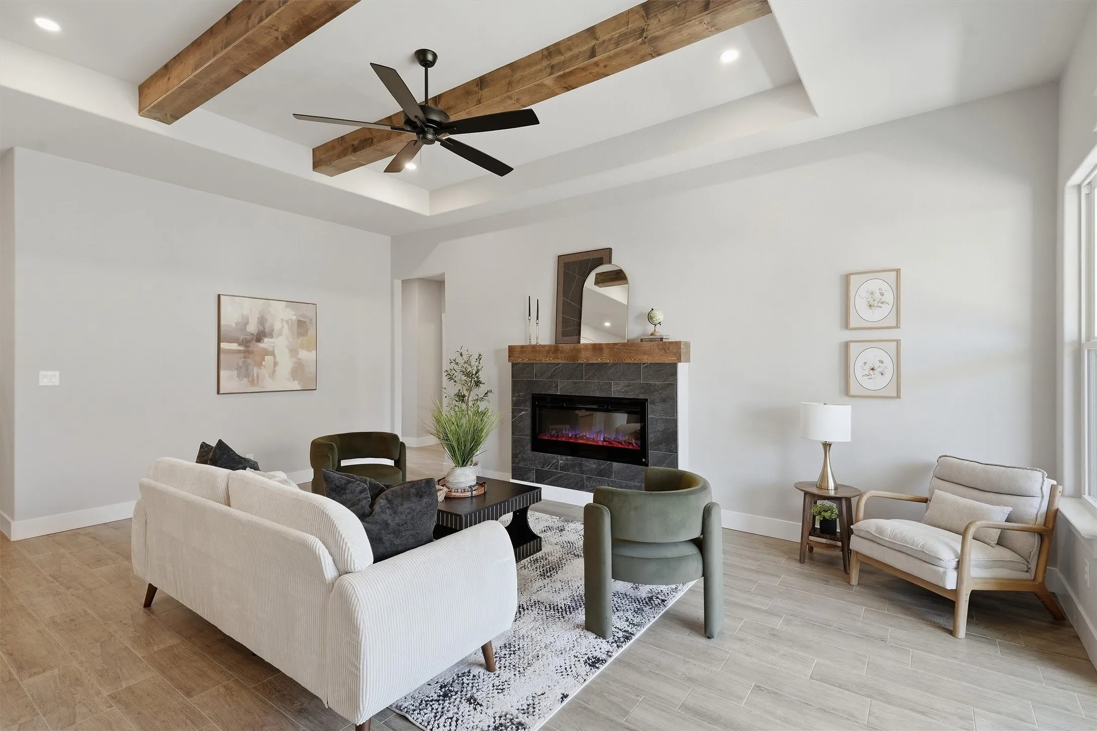 Tray ceiling with exposed wood beams, recessed lighting, and a ceiling fan