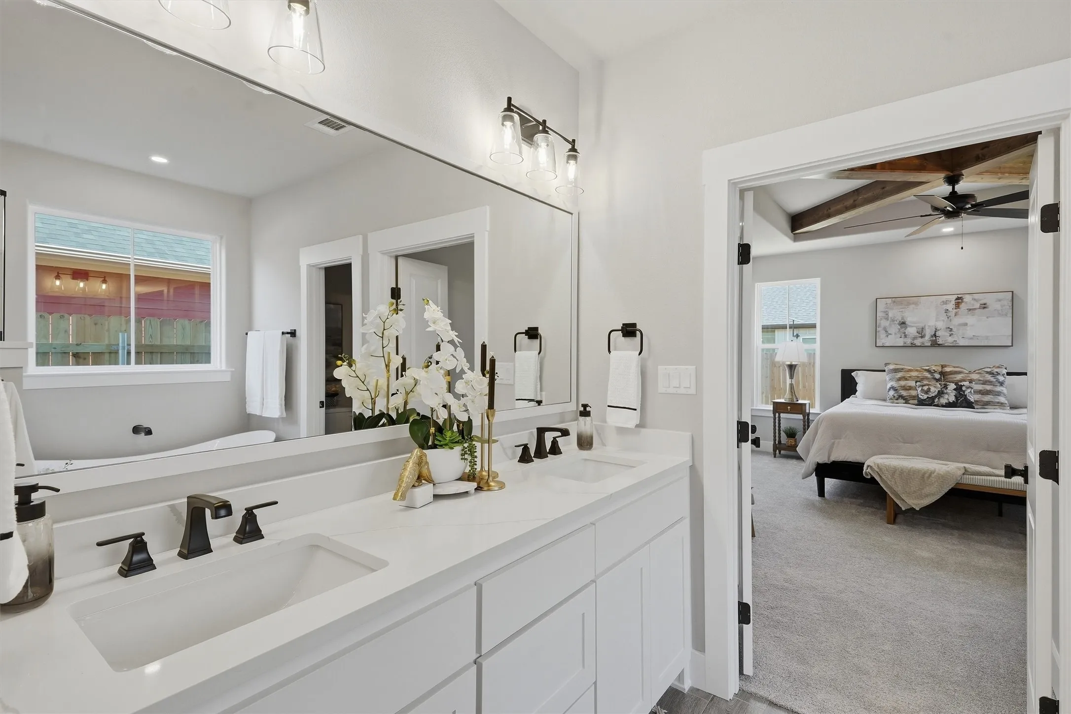 Double vanity with undermount sinks and dark bronze fixtures