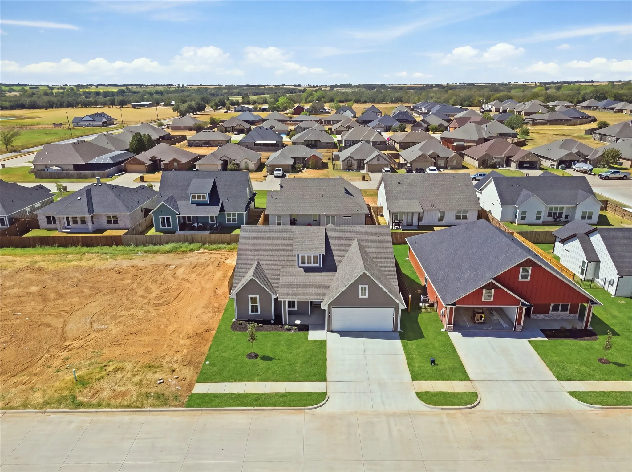 Contemporary residence with an attached garage, landscaped front yard, and a paved driveway