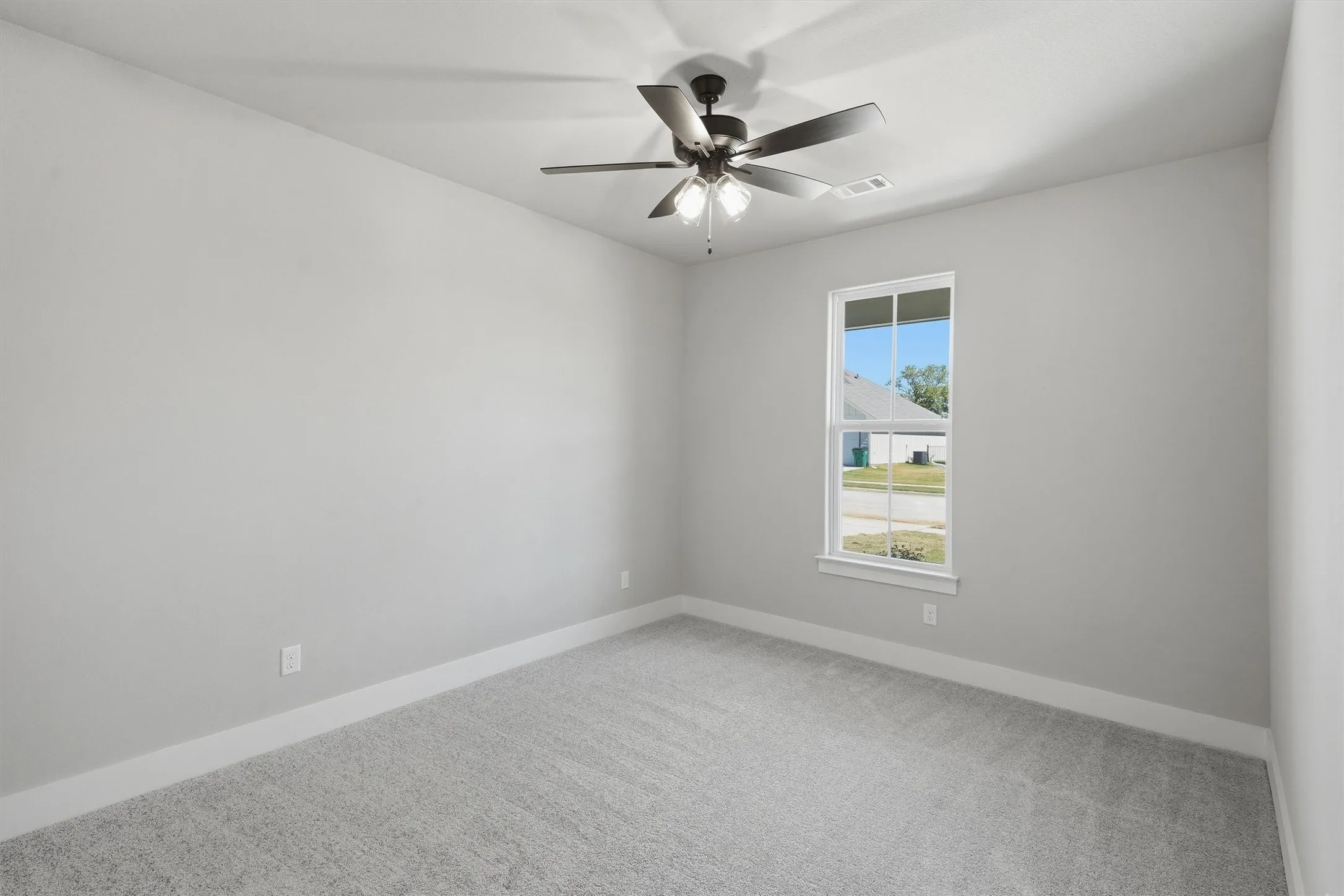Neutral-toned walls complement the light gray carpet
